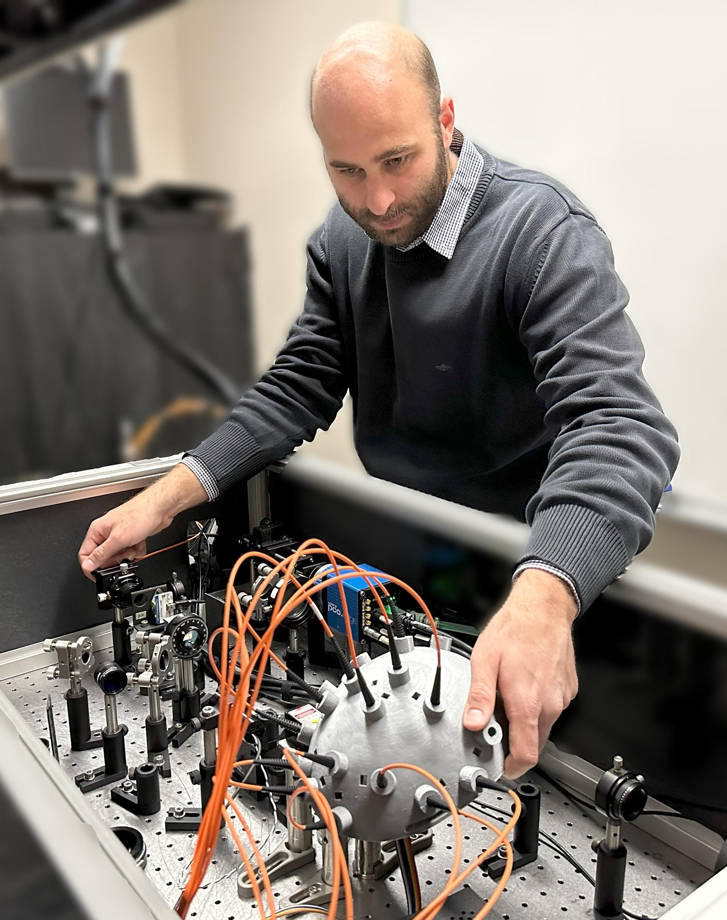 Simon Mahler working with lab equipment.
