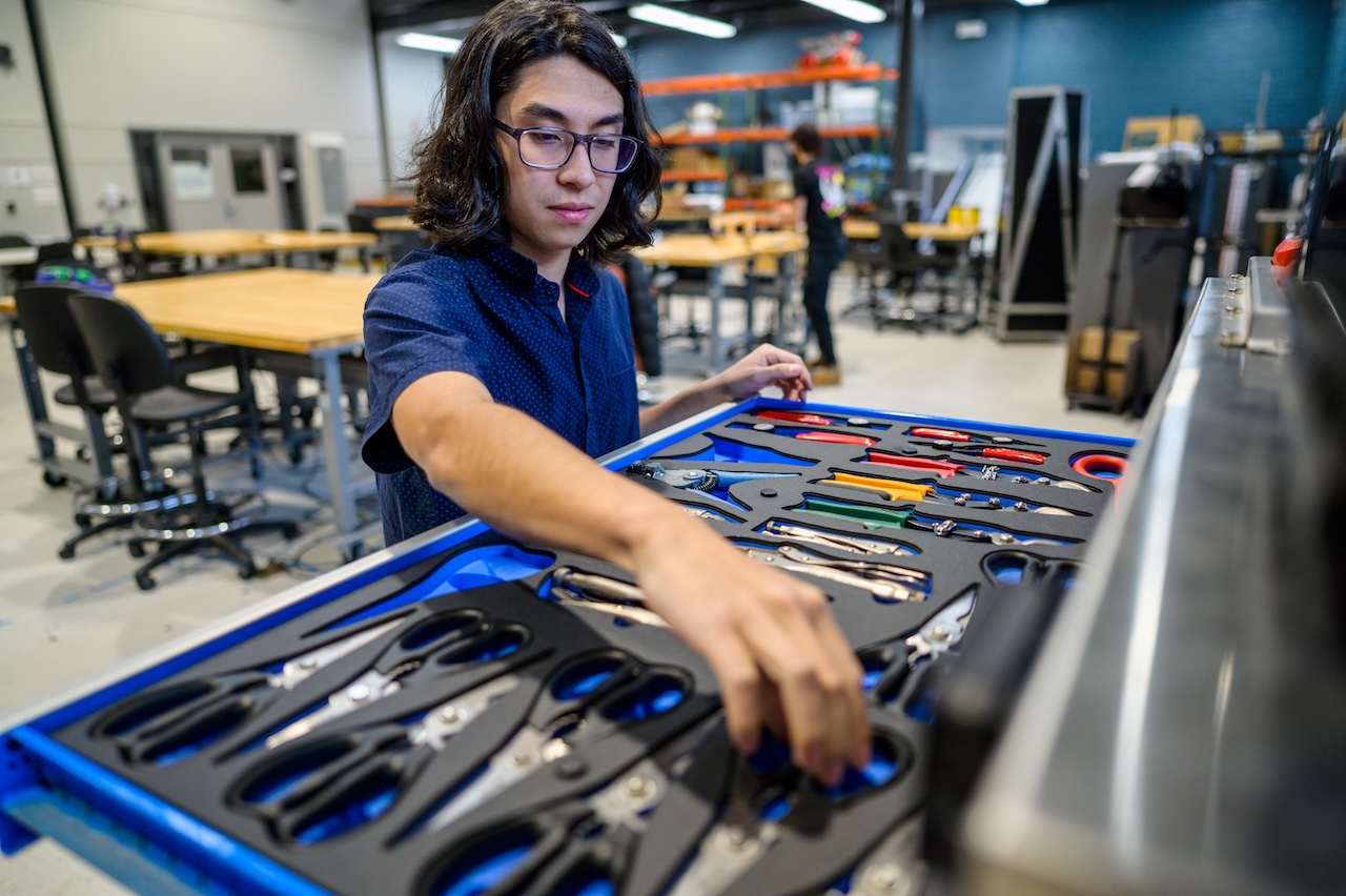 A student using the MakerCenter tool chest