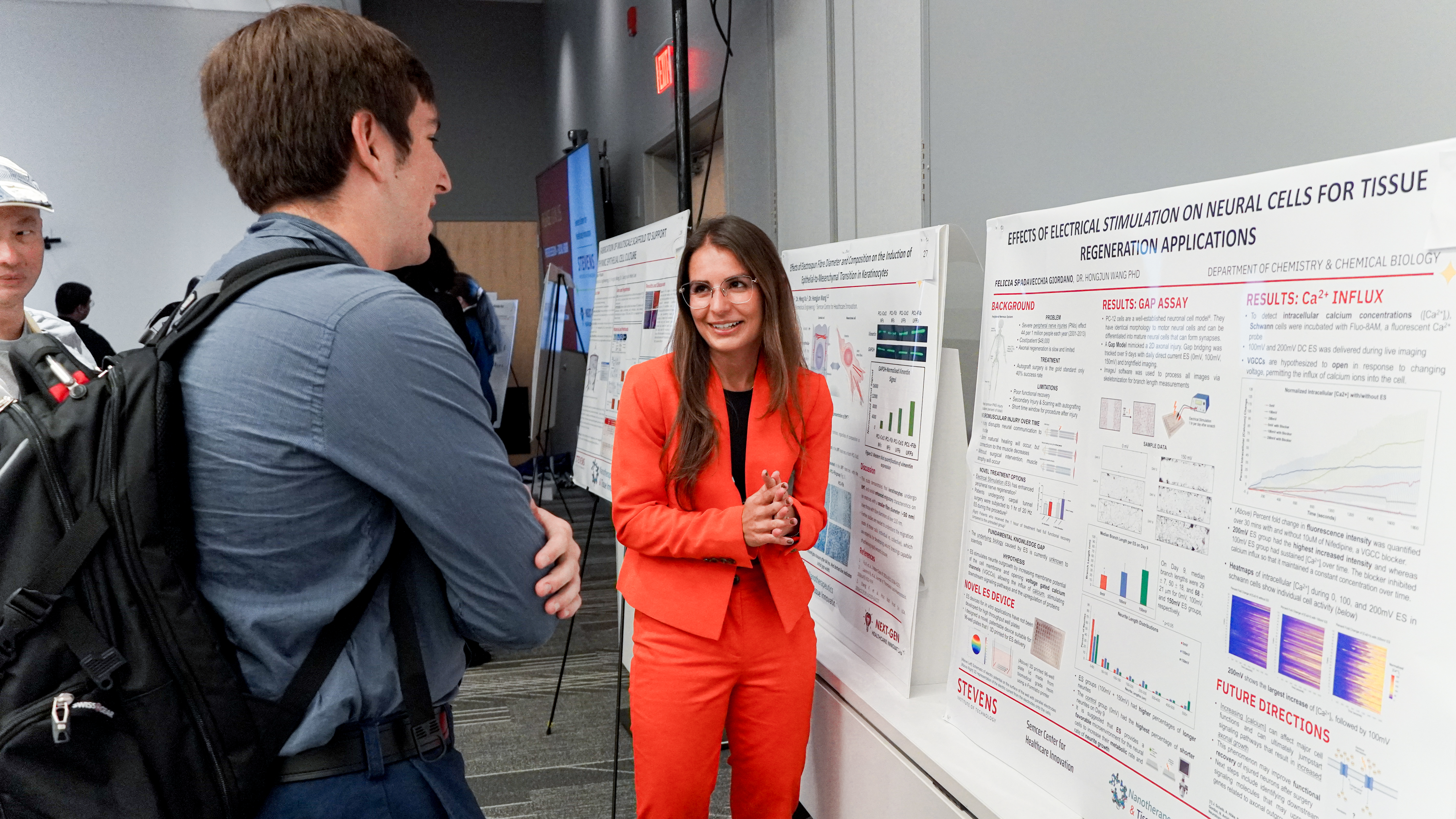 Stevens Ph.D. candidate Felicia Spadavecchia discusses her research with a fellow student.