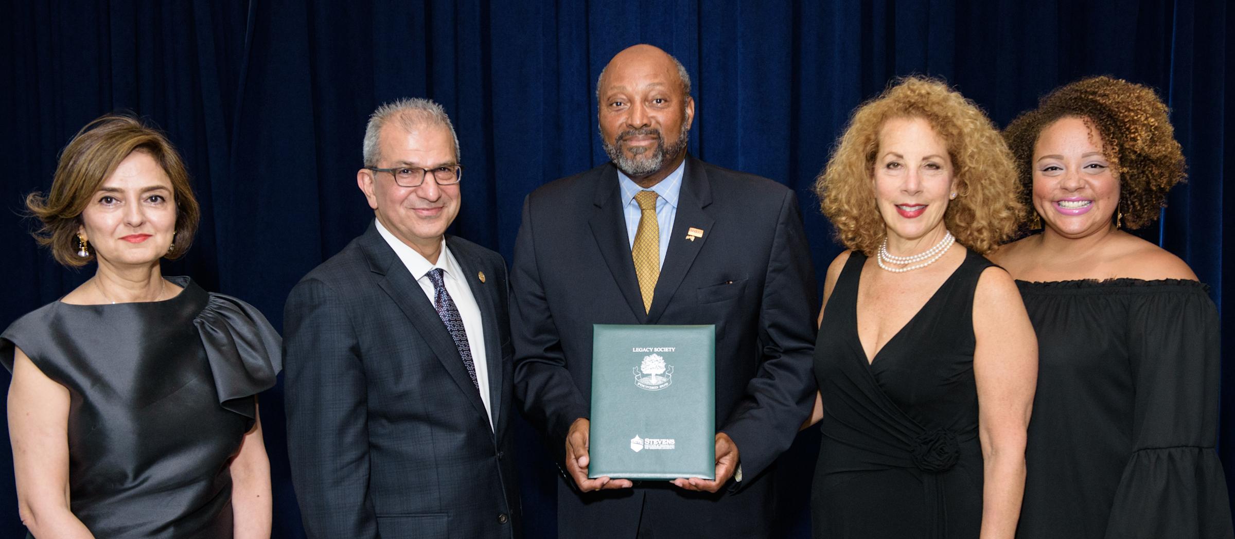 President Nariman Farvardin and Hoveida pose with alumni to recognize their membership in the Legacy Giving Society