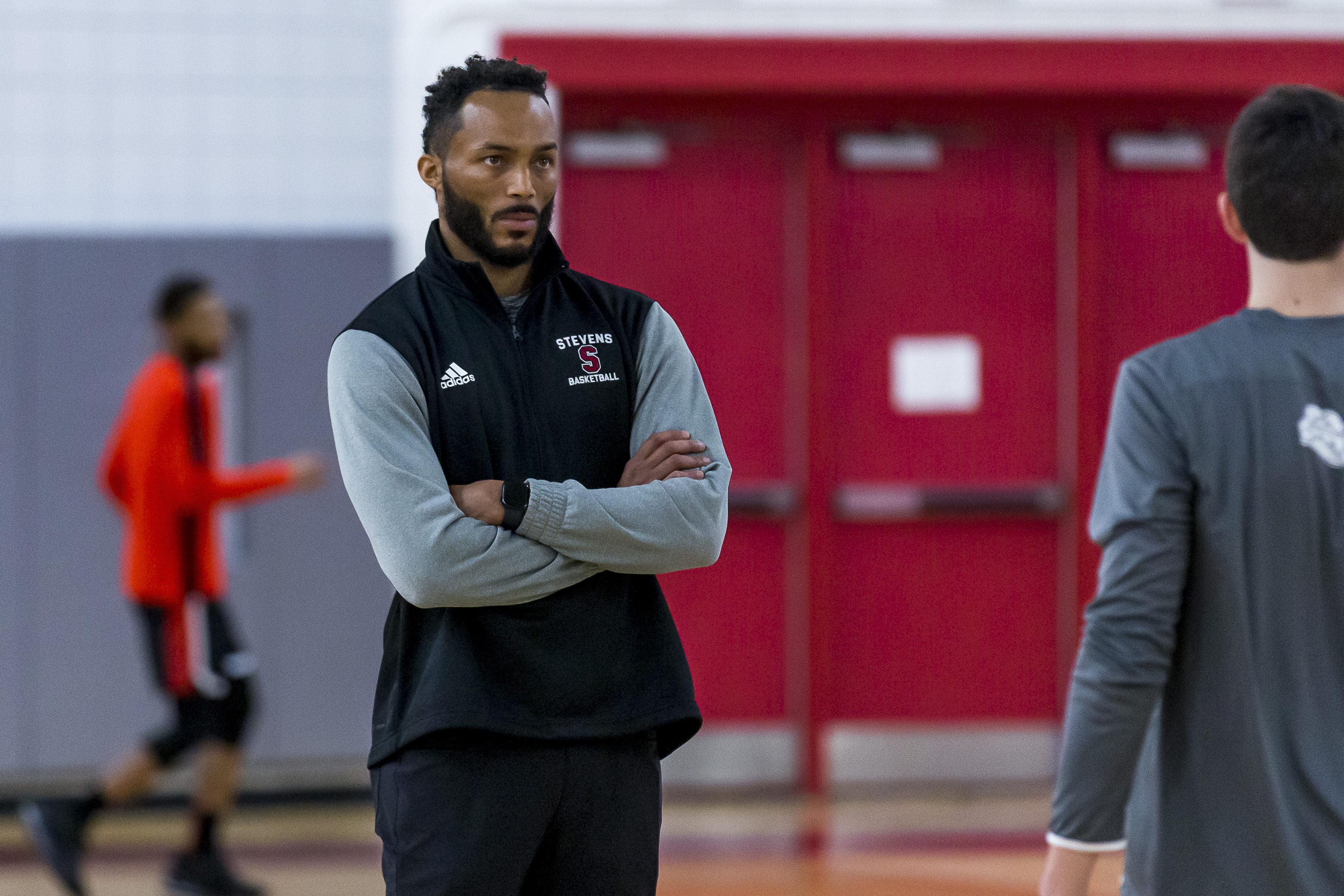 Michael Collins stands on the basketball court