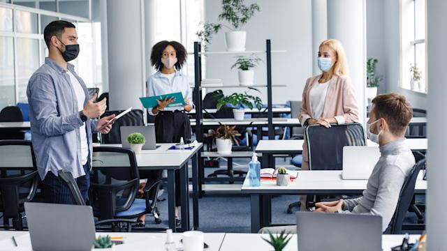 Meeting and reporting on project or team building by employees and boss in office interior with devices