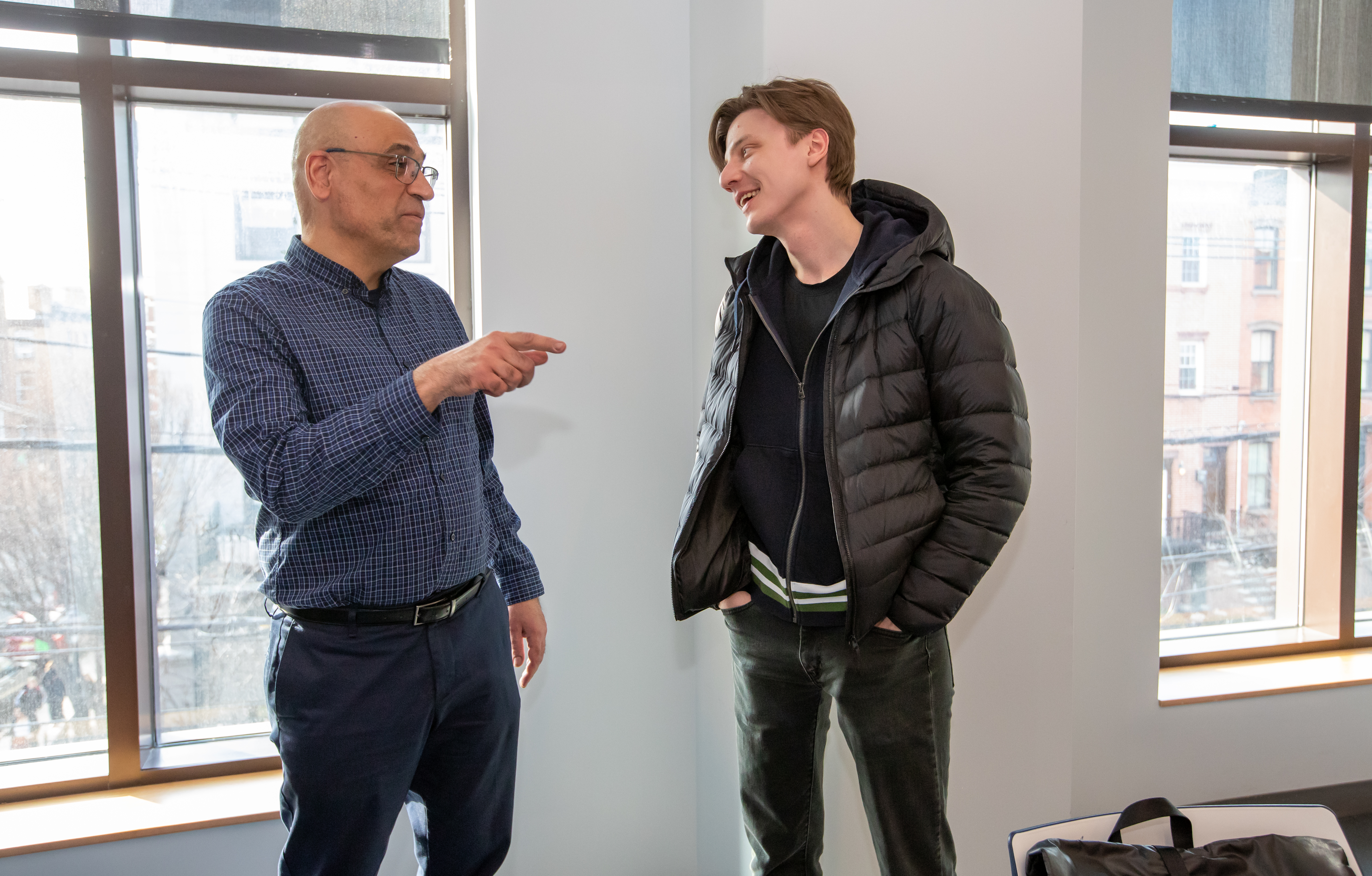 A male faculty talking to a male student