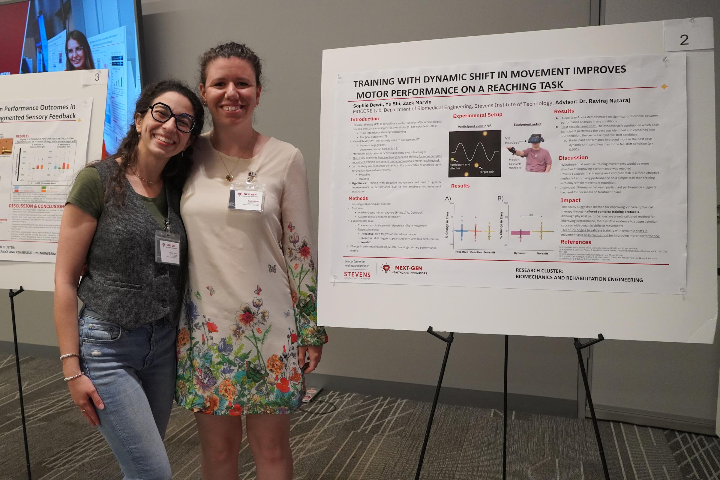 Ph.D. Students Zahava Hirsch and Sophie DeWitt stand in front of a poster presentation.