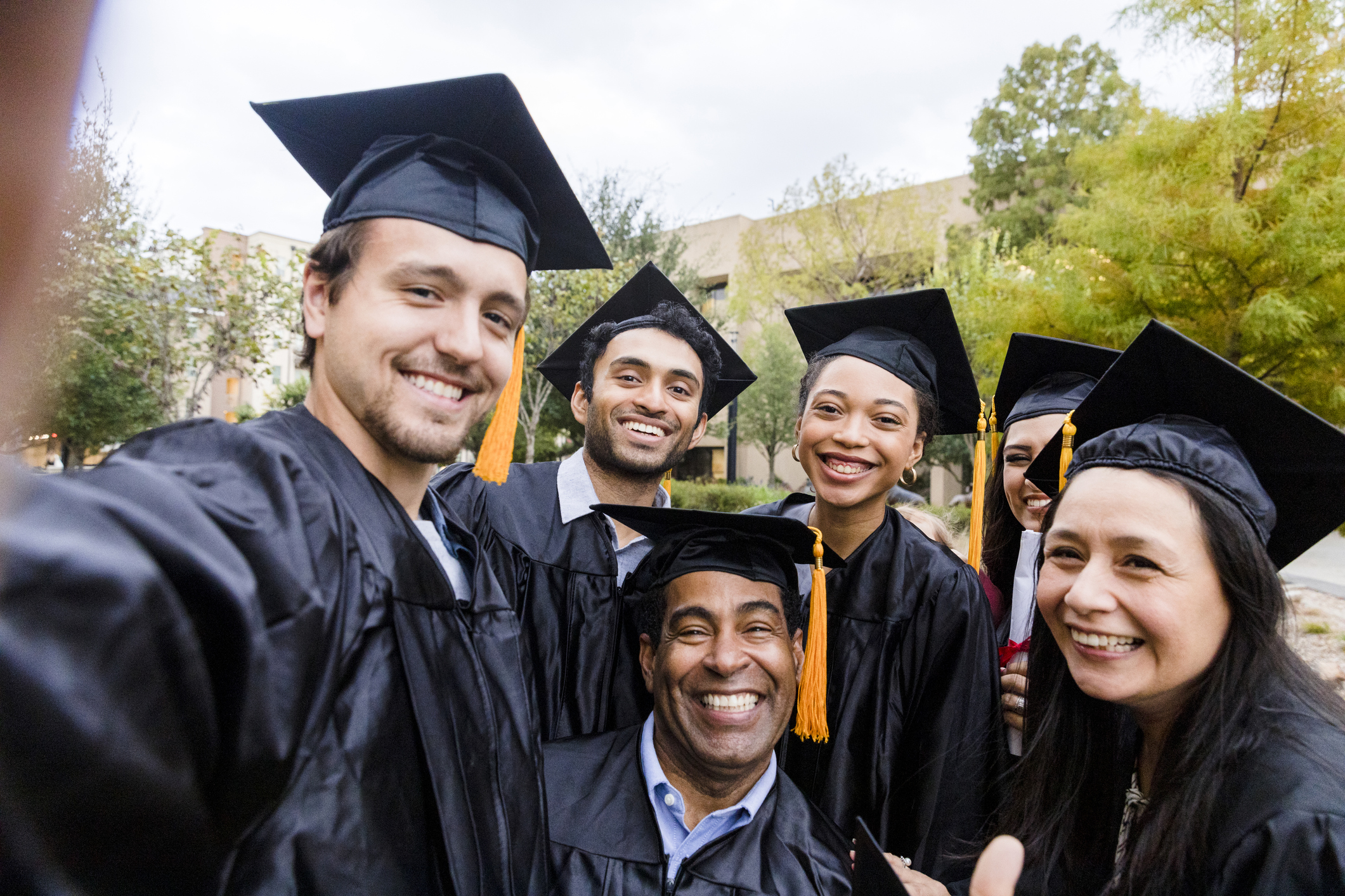 a group of older students in graduation caps and gowns 
