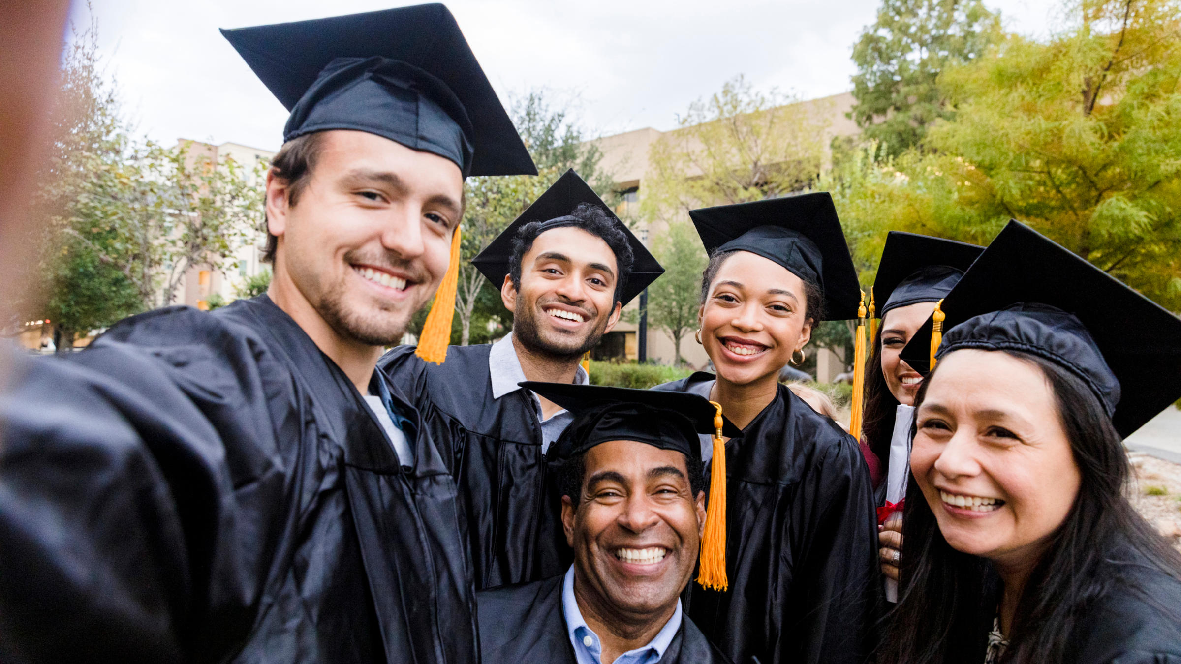 a group of older students in graduation caps and gowns