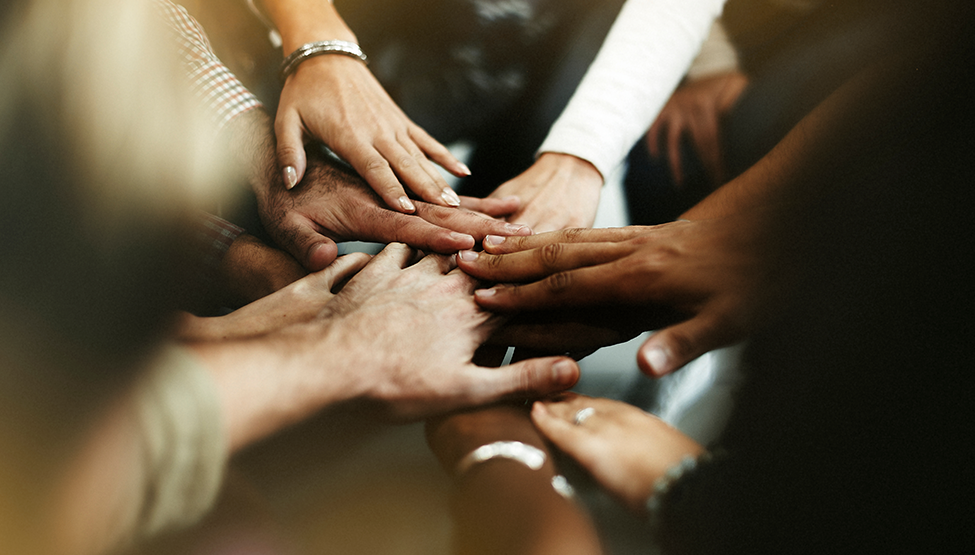 Diverse hands meet in the middle