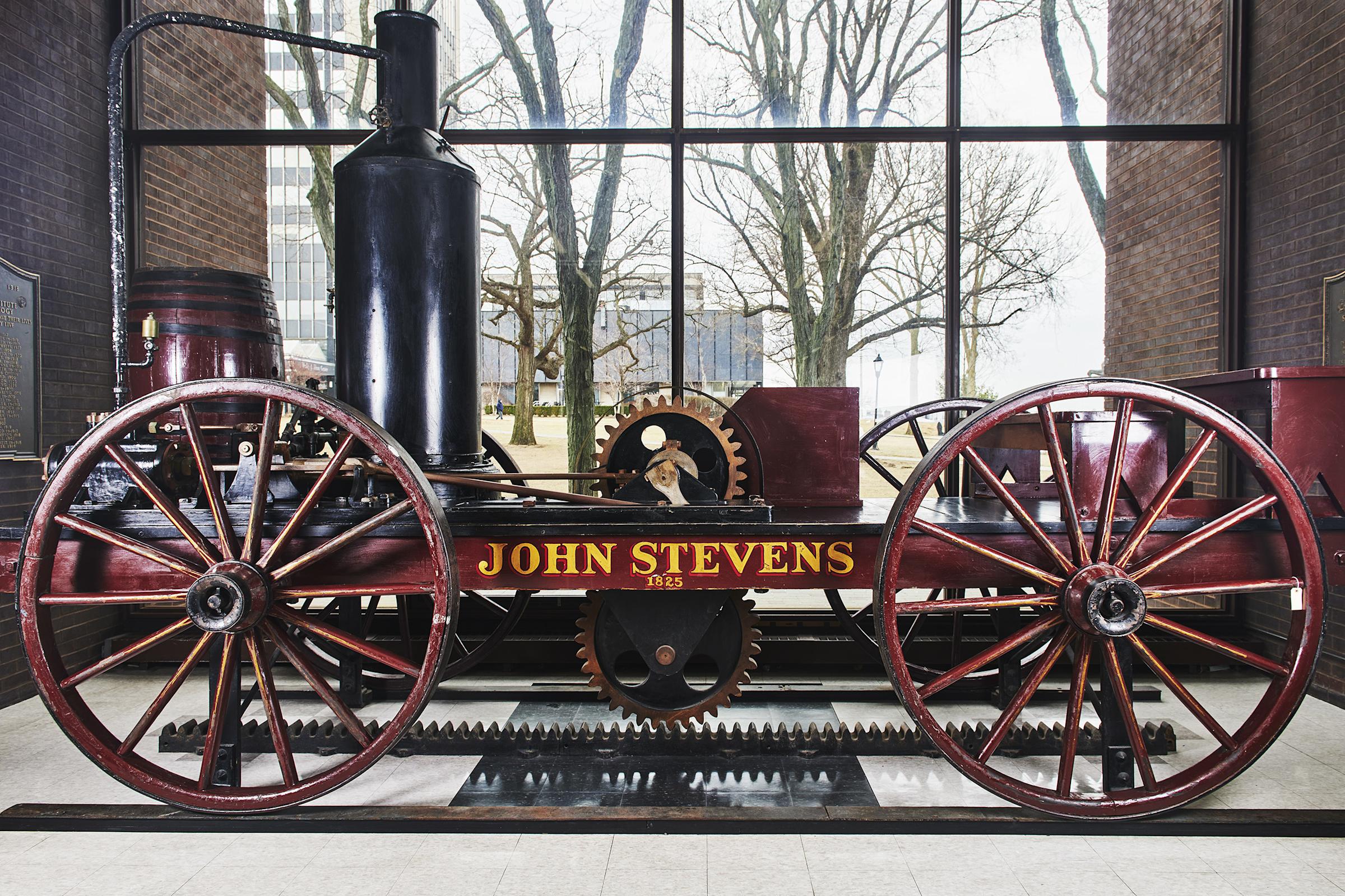 Replica of the steam locamotive, about 15 feet long, in window of library.