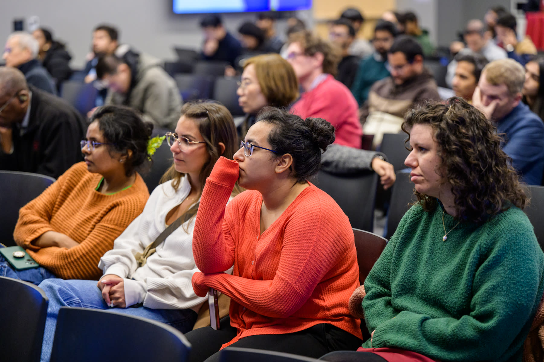 An auditorium with Stevens students and faculty watching a presentation.