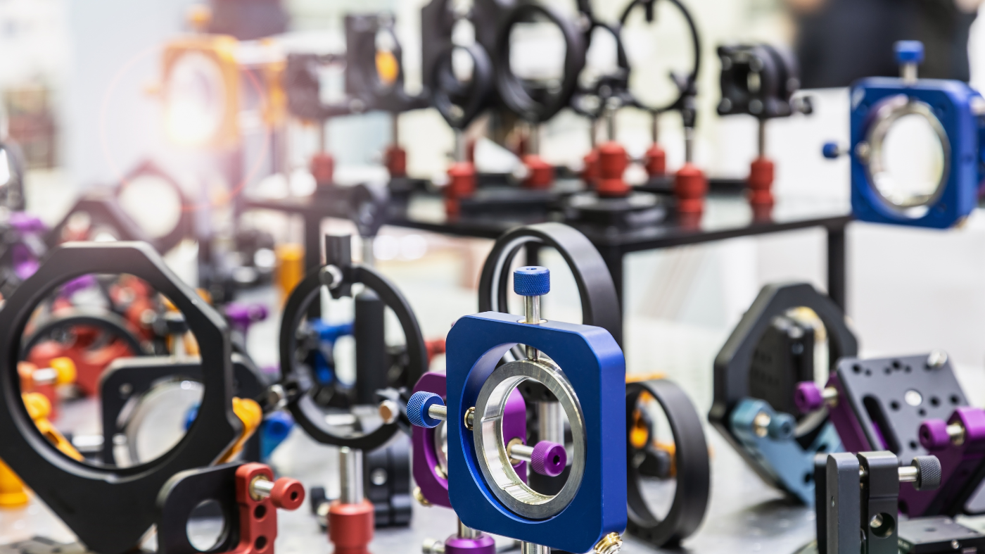 optics and laser holders with motorized positioners on an optical table.