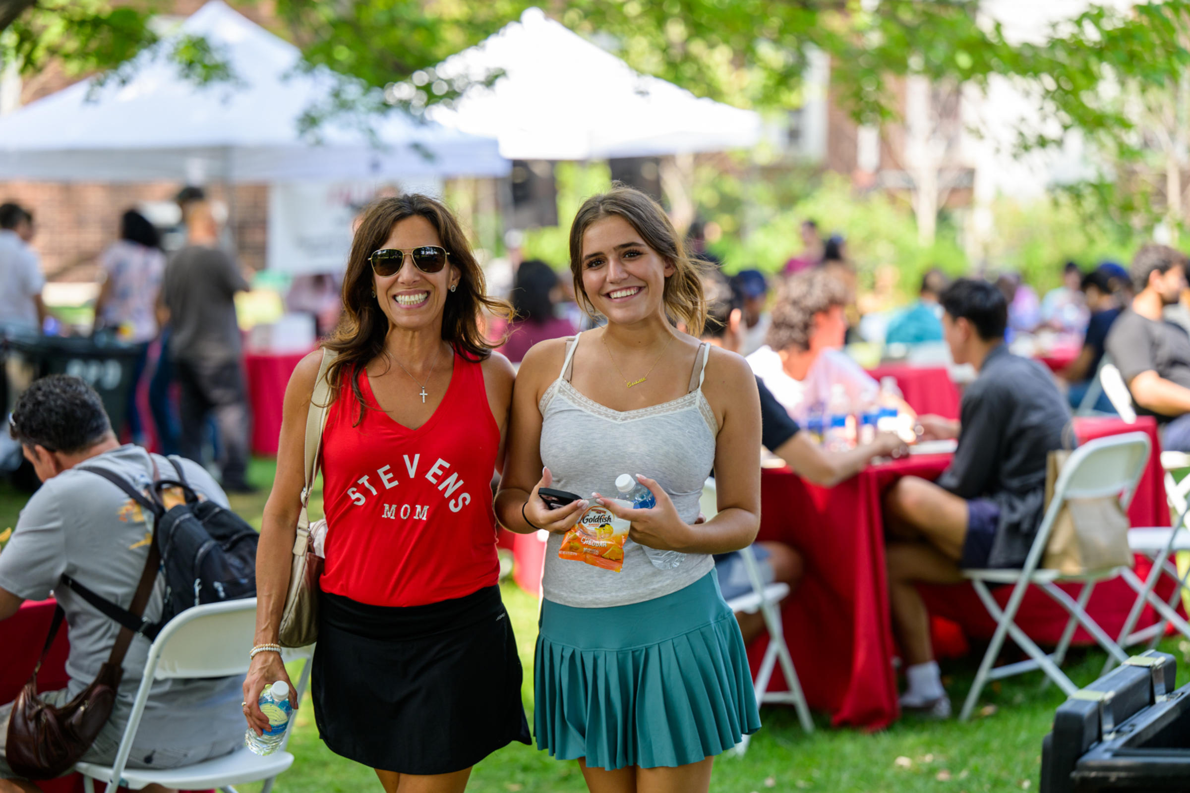 A woman in a Stevens Mom shirt poses with a woman student.