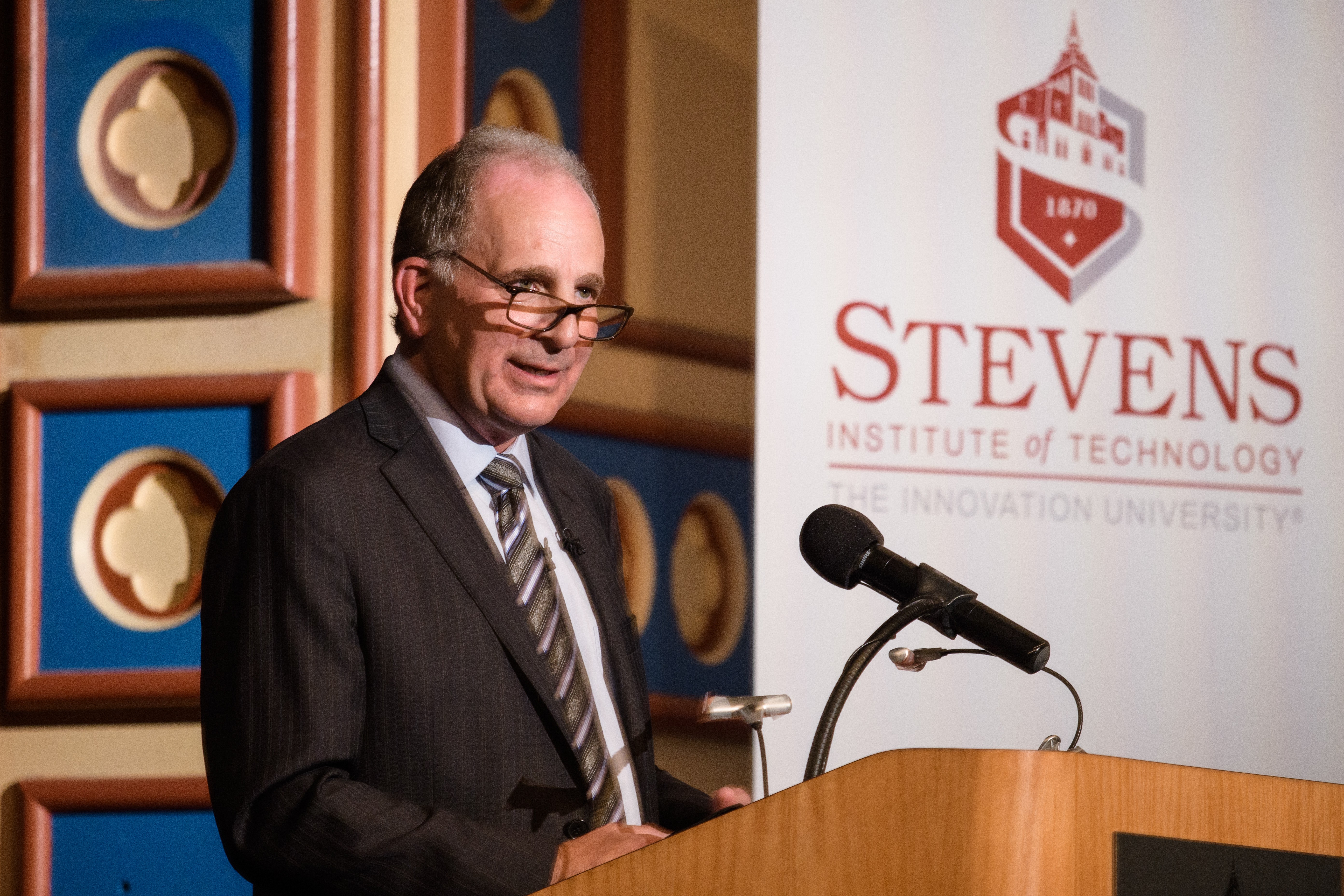 Bruce H. March, president of ExxonMobil Research and Engineering Company, at the podium on stage in DeBaun Auditorium at Stevens