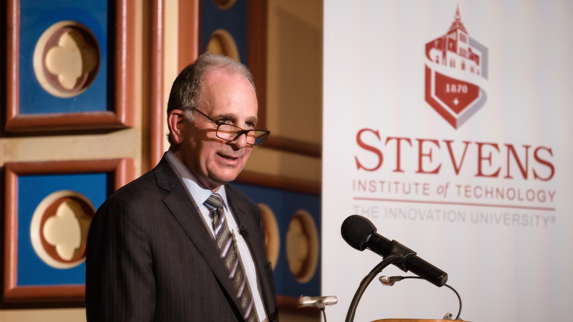 Bruce H. March, president of ExxonMobil Research and Engineering Company, at the podium on stage in DeBaun Auditorium at Stevens