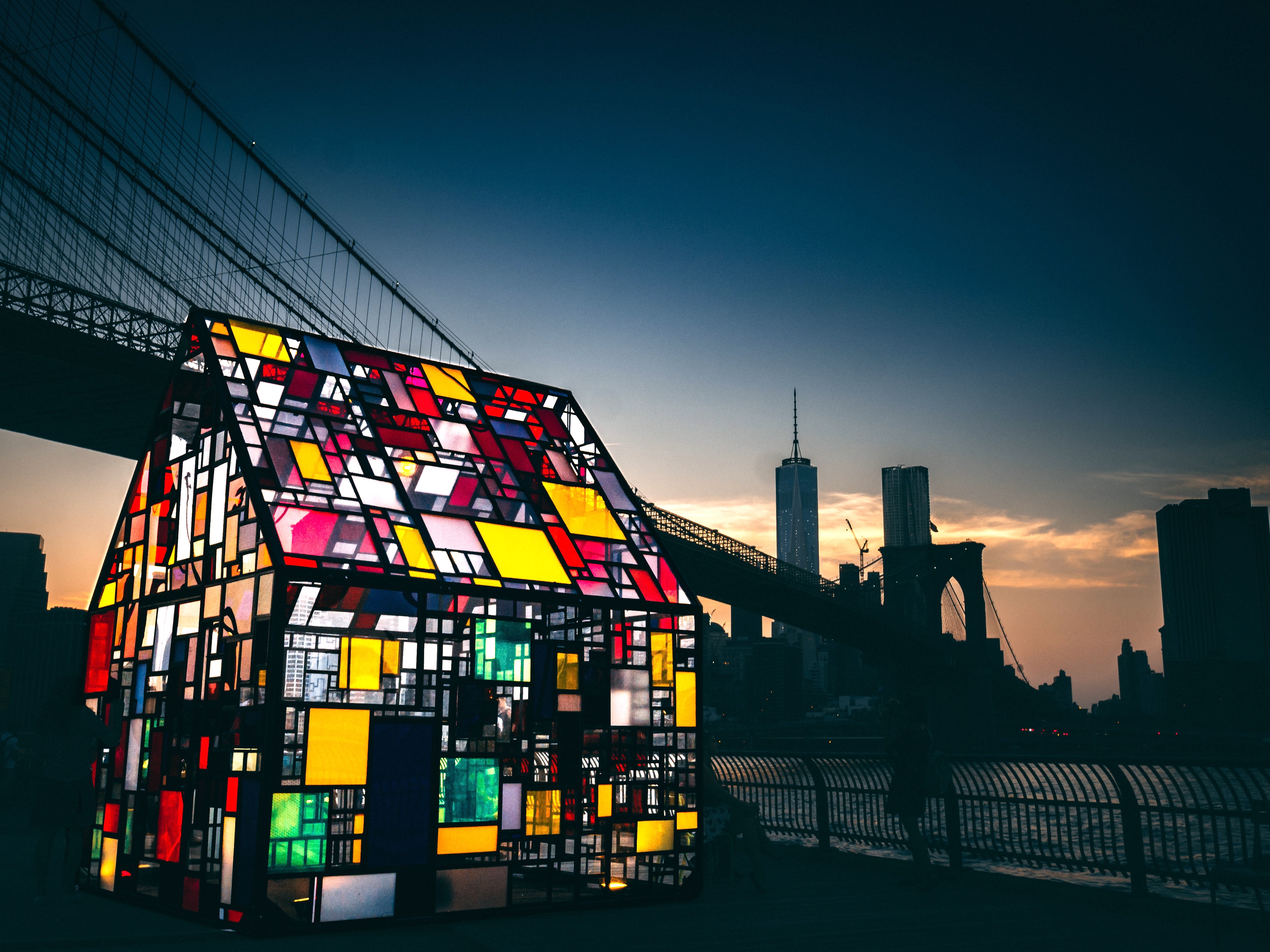 Mosaic-colored glass house by a New York City river
