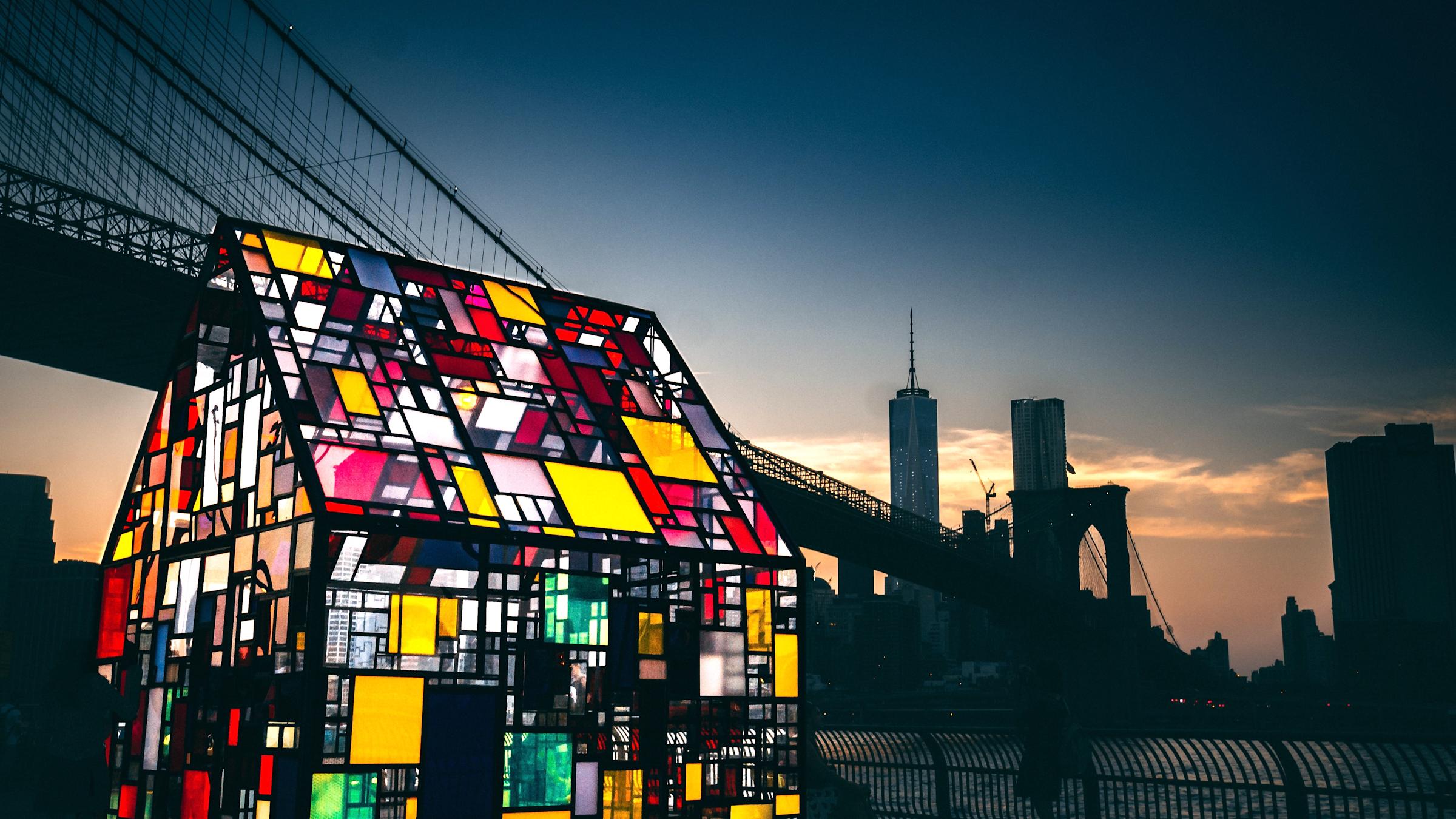 Mosaic-colored glass house by a New York City river