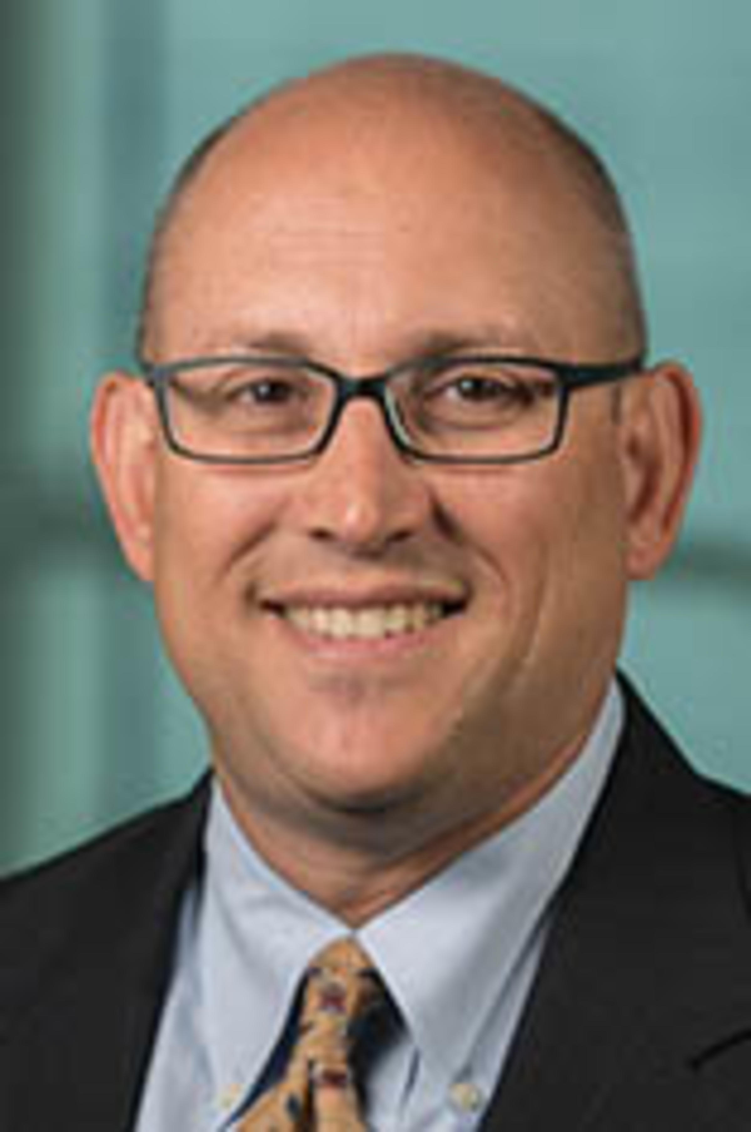 Headshot of Dr. Paul Rohmeyer with New York City in the background.