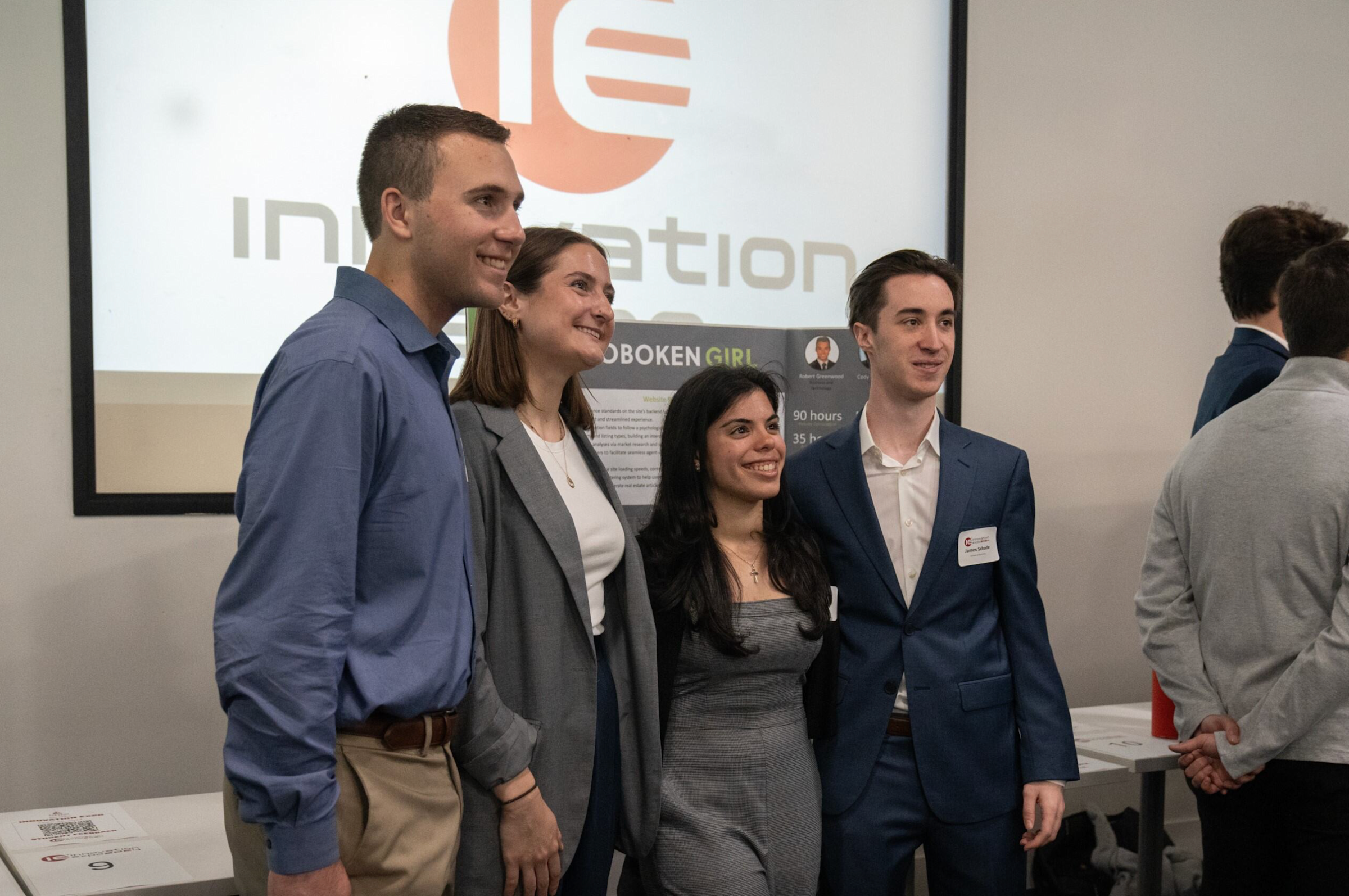 Four members of the Hoboken Girl group pose in front of their posterboard.