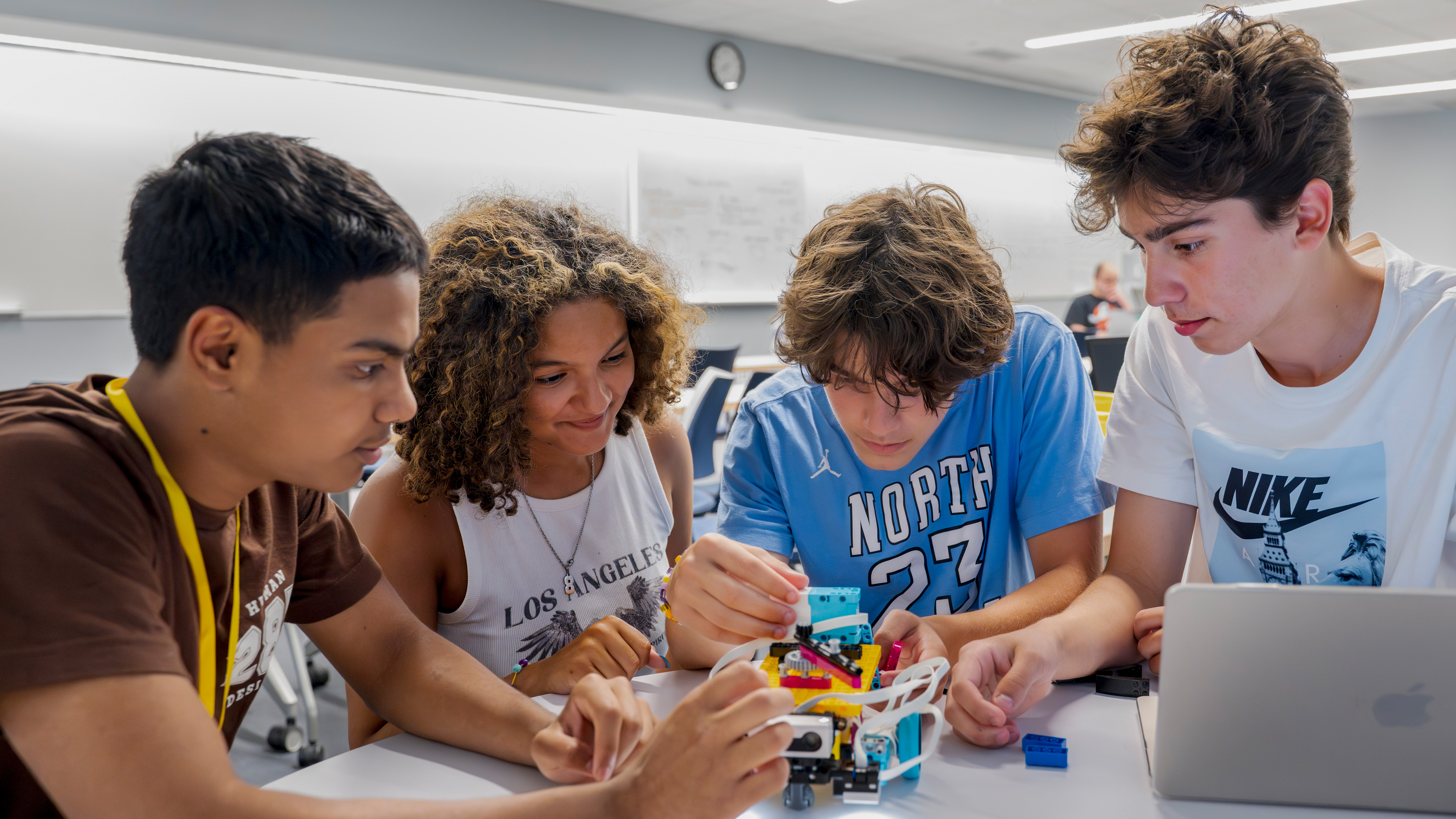 Students working together in lab on small robot
