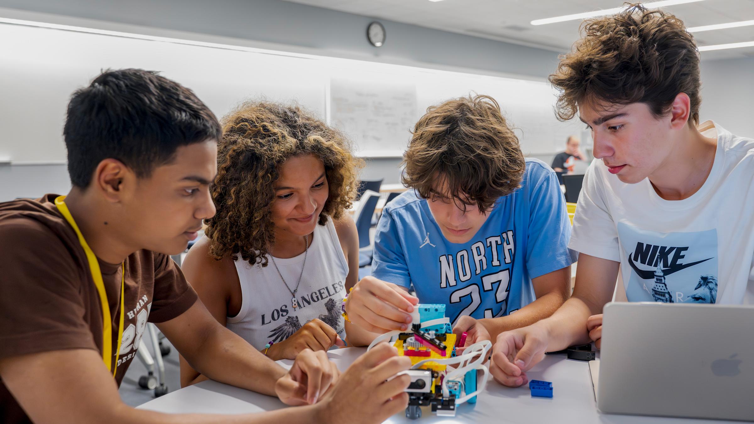 Students working together in lab on small robot