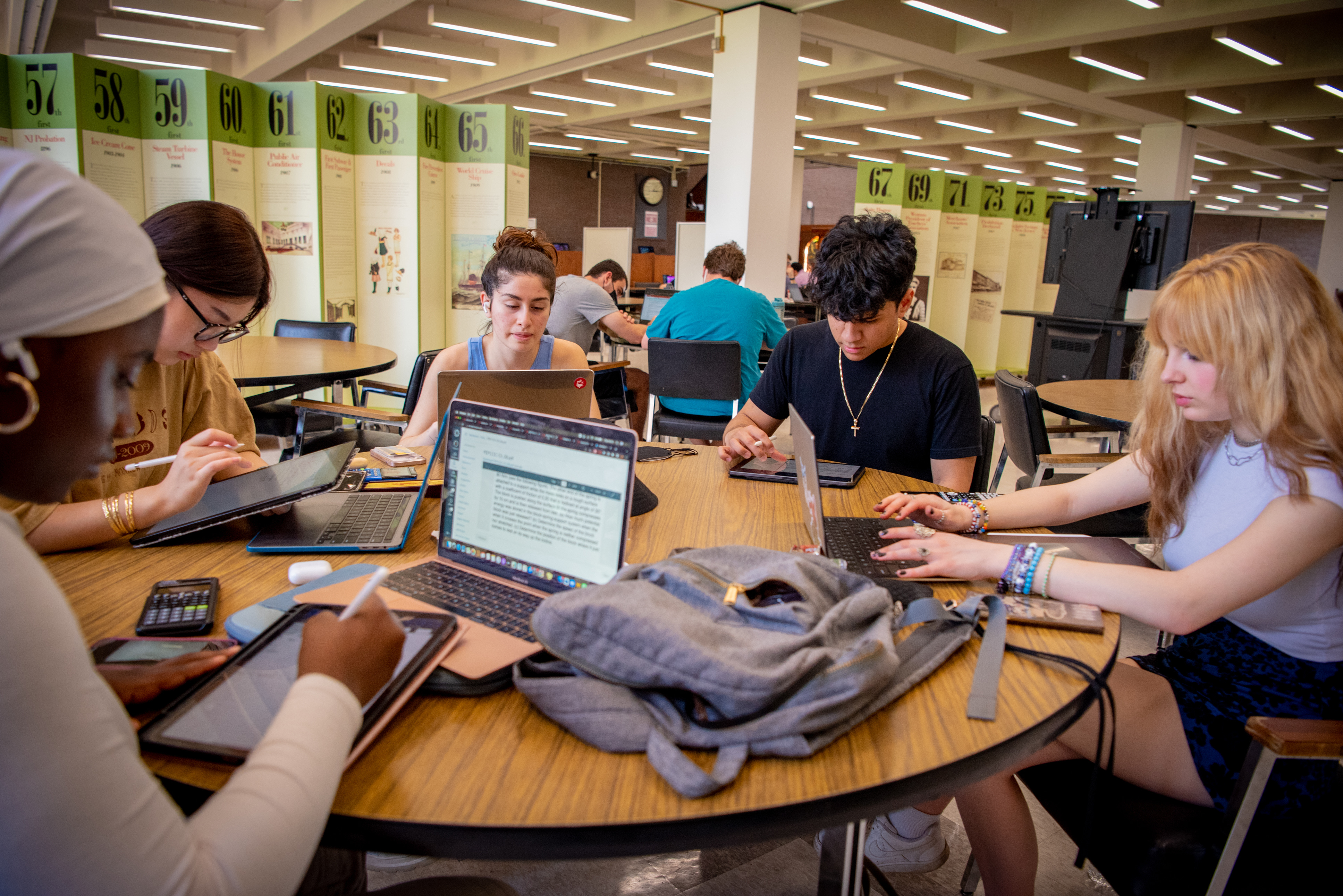 Students working at a round table. 