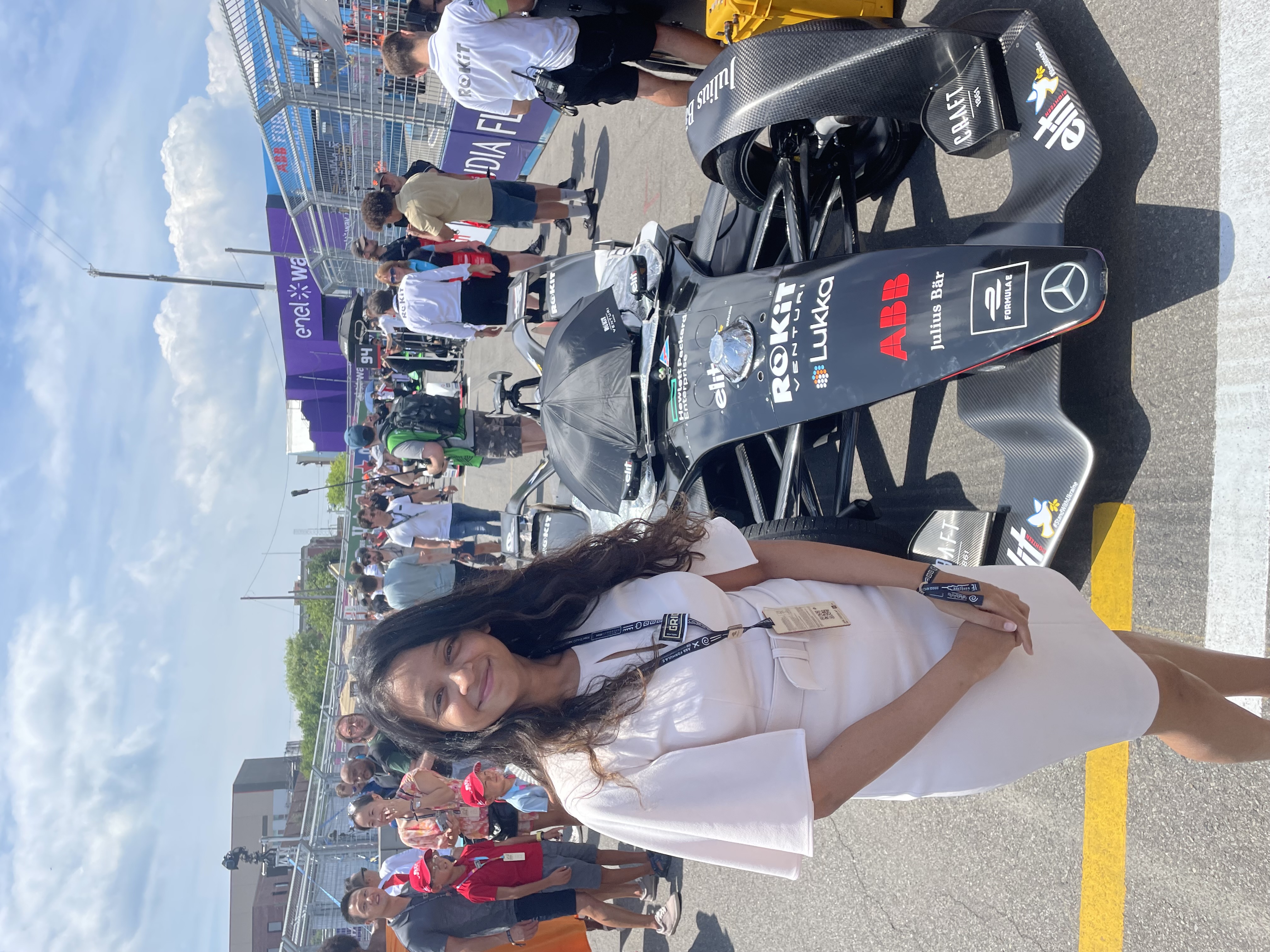 Kinjal Shukla stands next to a blue Formula E race car.