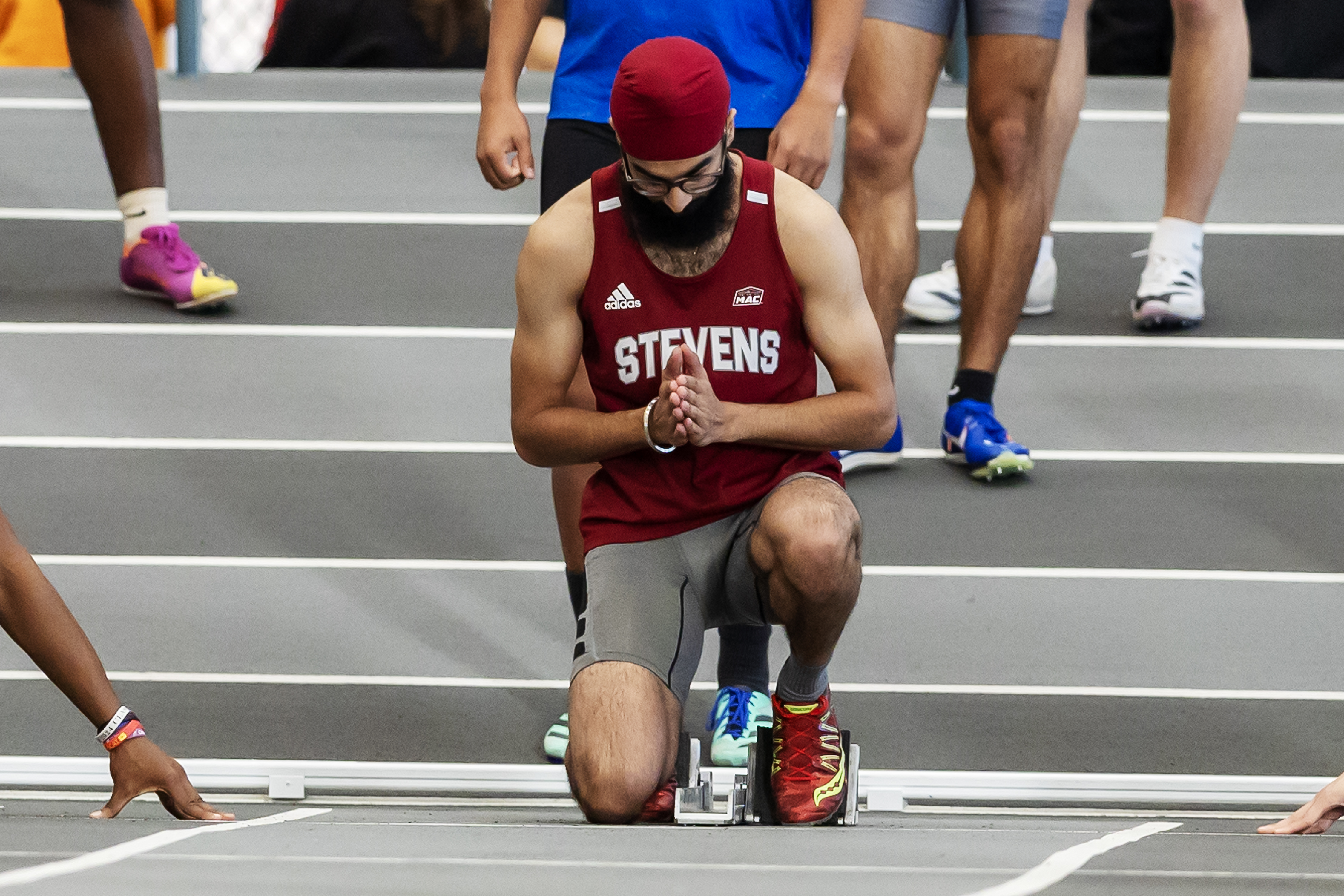 Rai Singh Bindra kneeling down moments before running in a track race