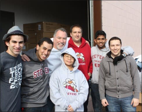 Professor Don Lombardi stands with a group of students after handing out food after Hurricane Sandy.