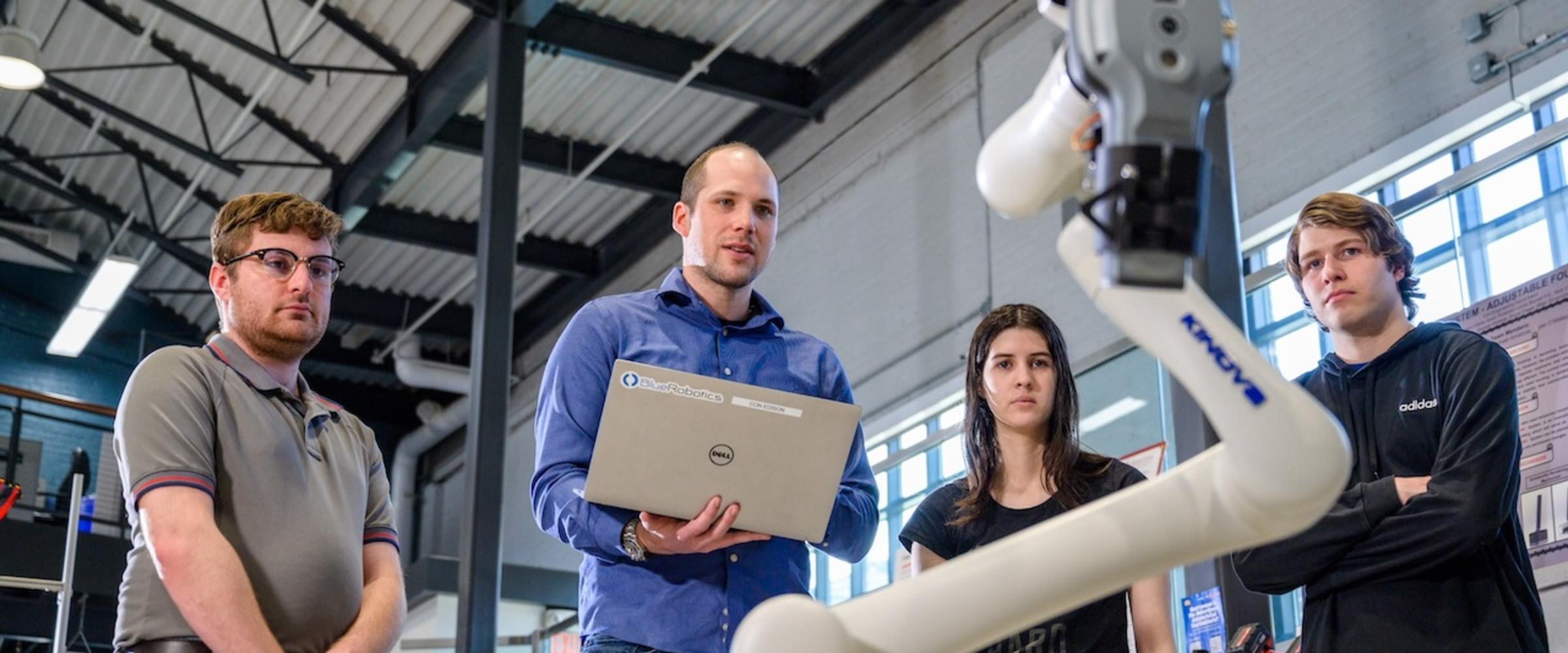 Students in the MakerCenter testing a robot