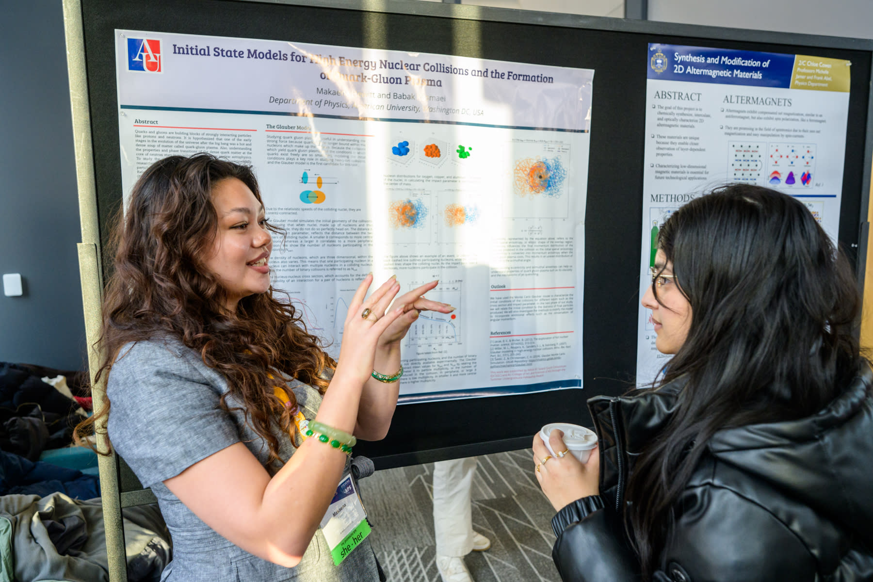  Two students discuss a poster presentation.
