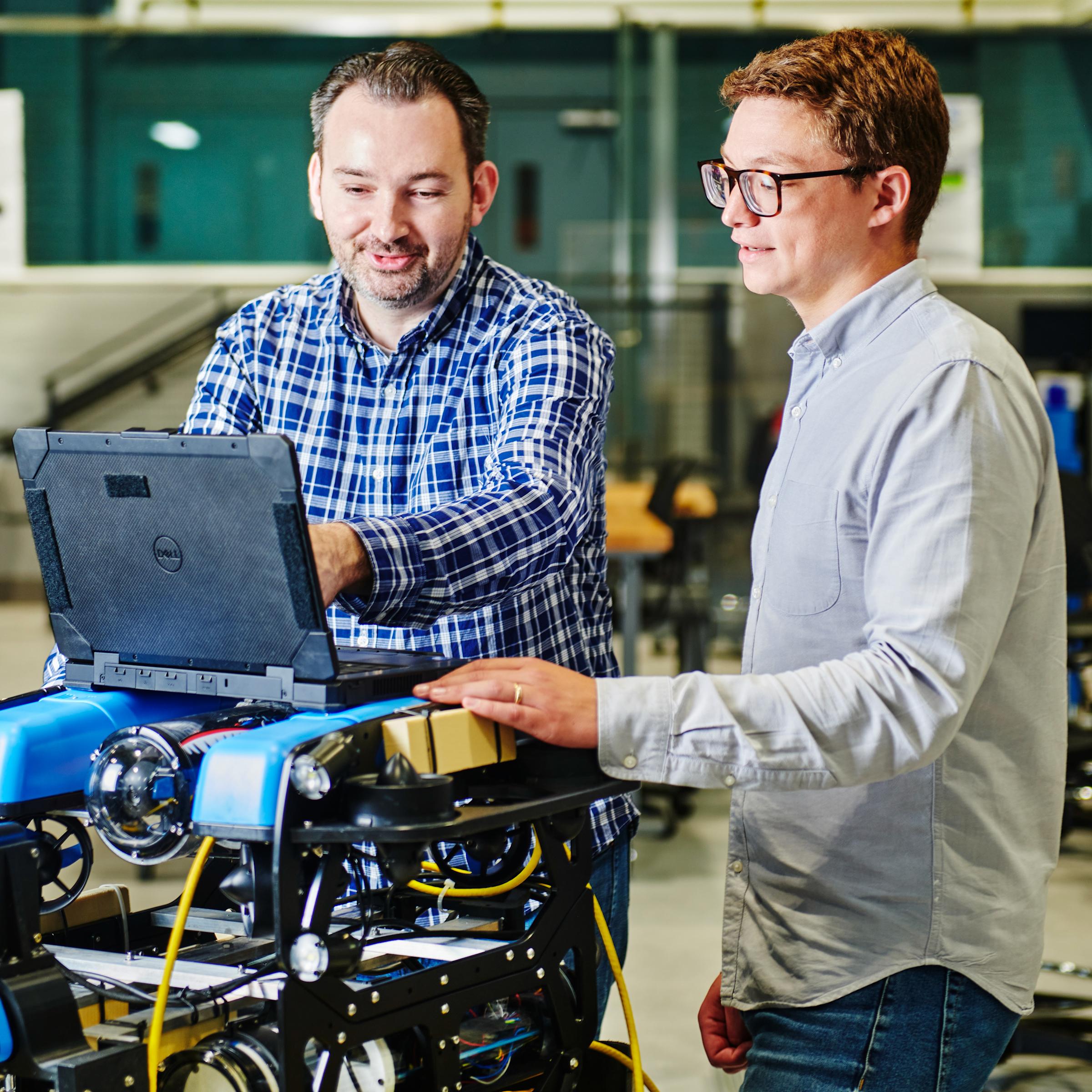 Brendan Englot and John McConnell working on the BlueROV robot inside Stevens’ ABS Engineering Center MakerSpace.