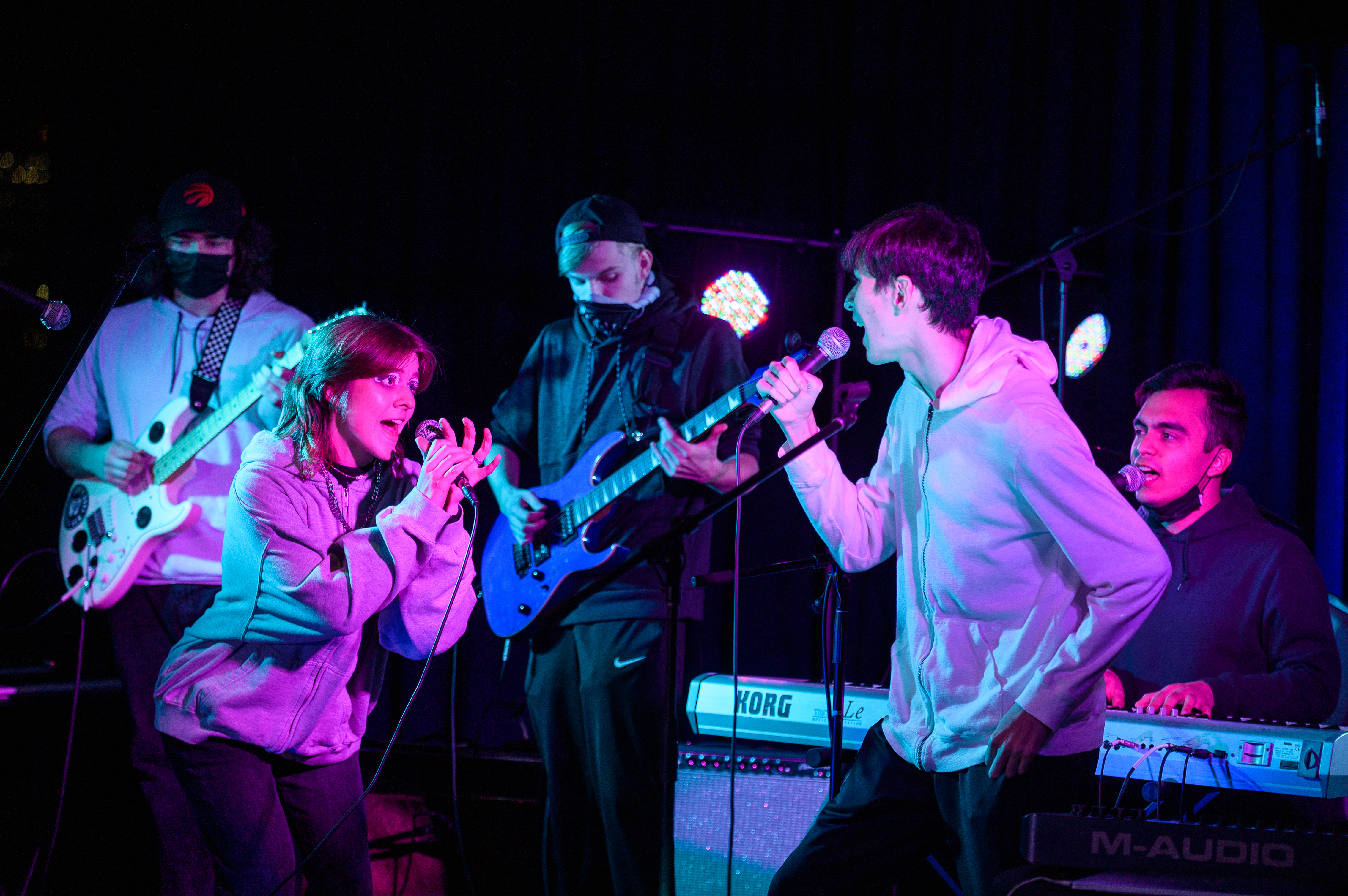 Three musicians and two singers perform as an ensemble