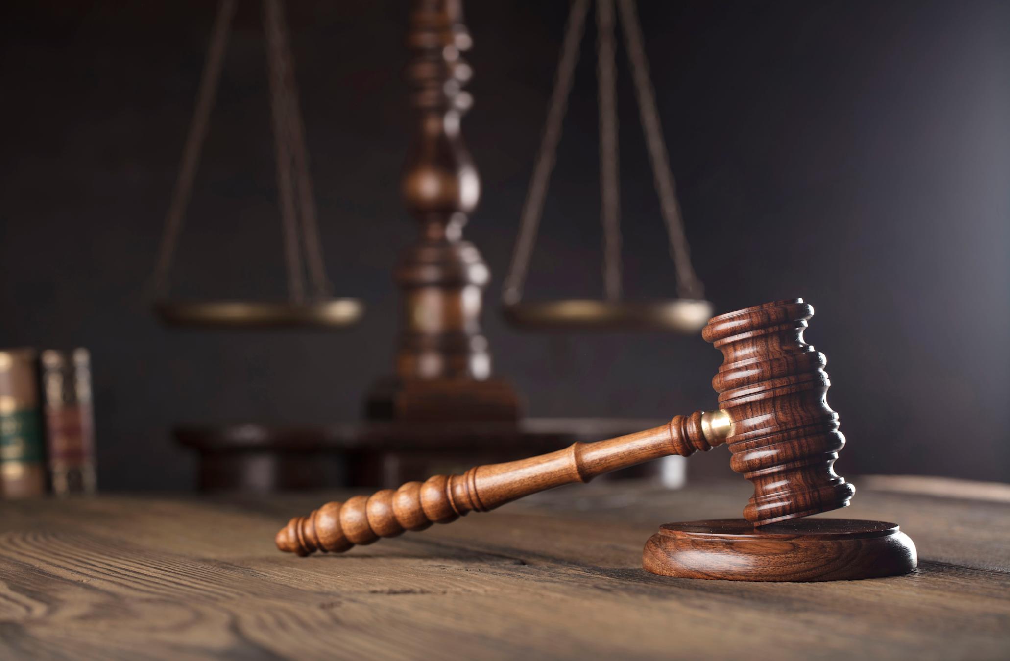 Gavel on desk with scales in background
