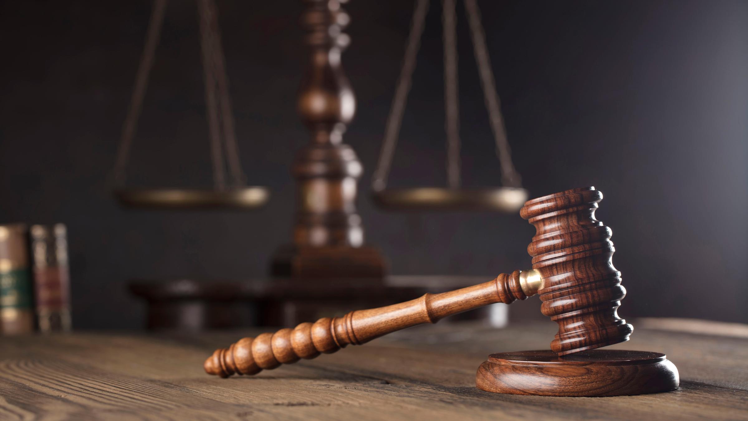 Gavel on desk with scales in background