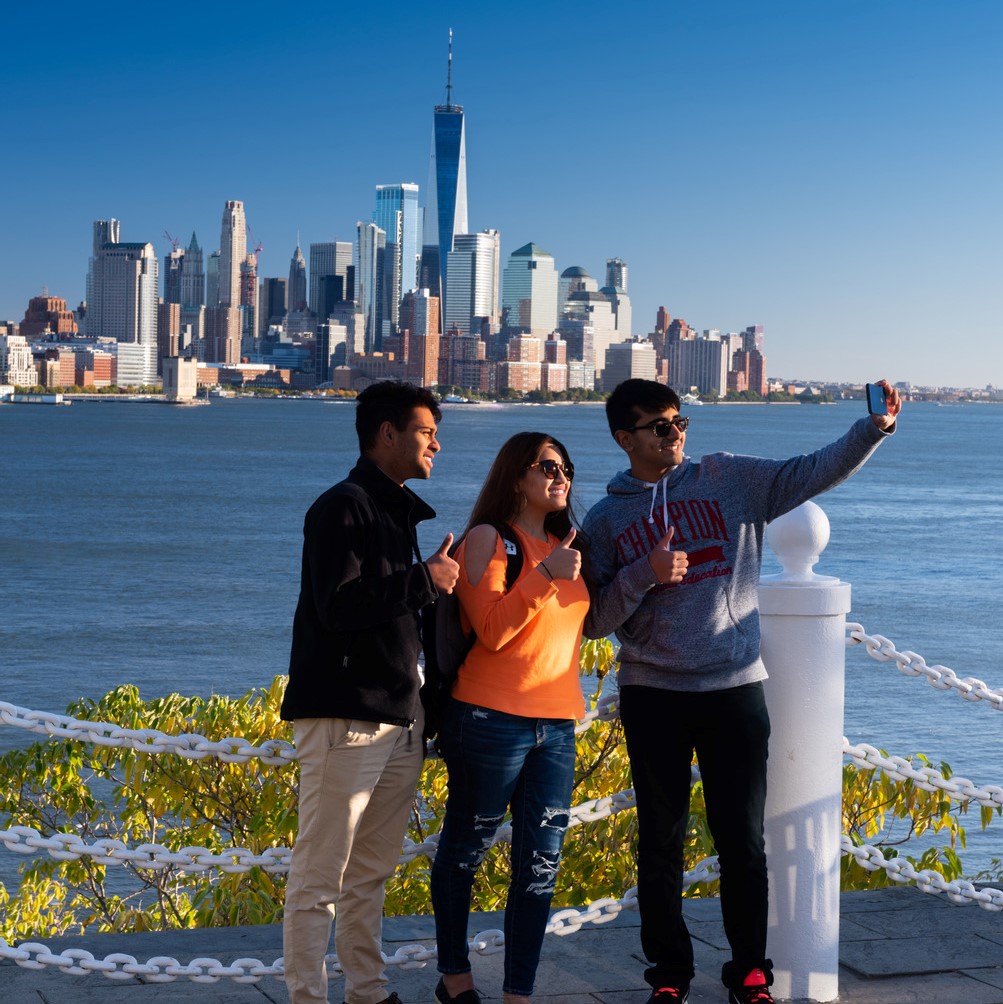 A group of three individuals take a selfie at Castle Point