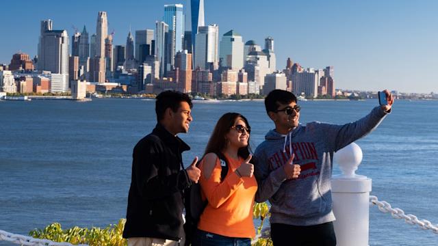 A group of three individuals take a selfie at Castle Point