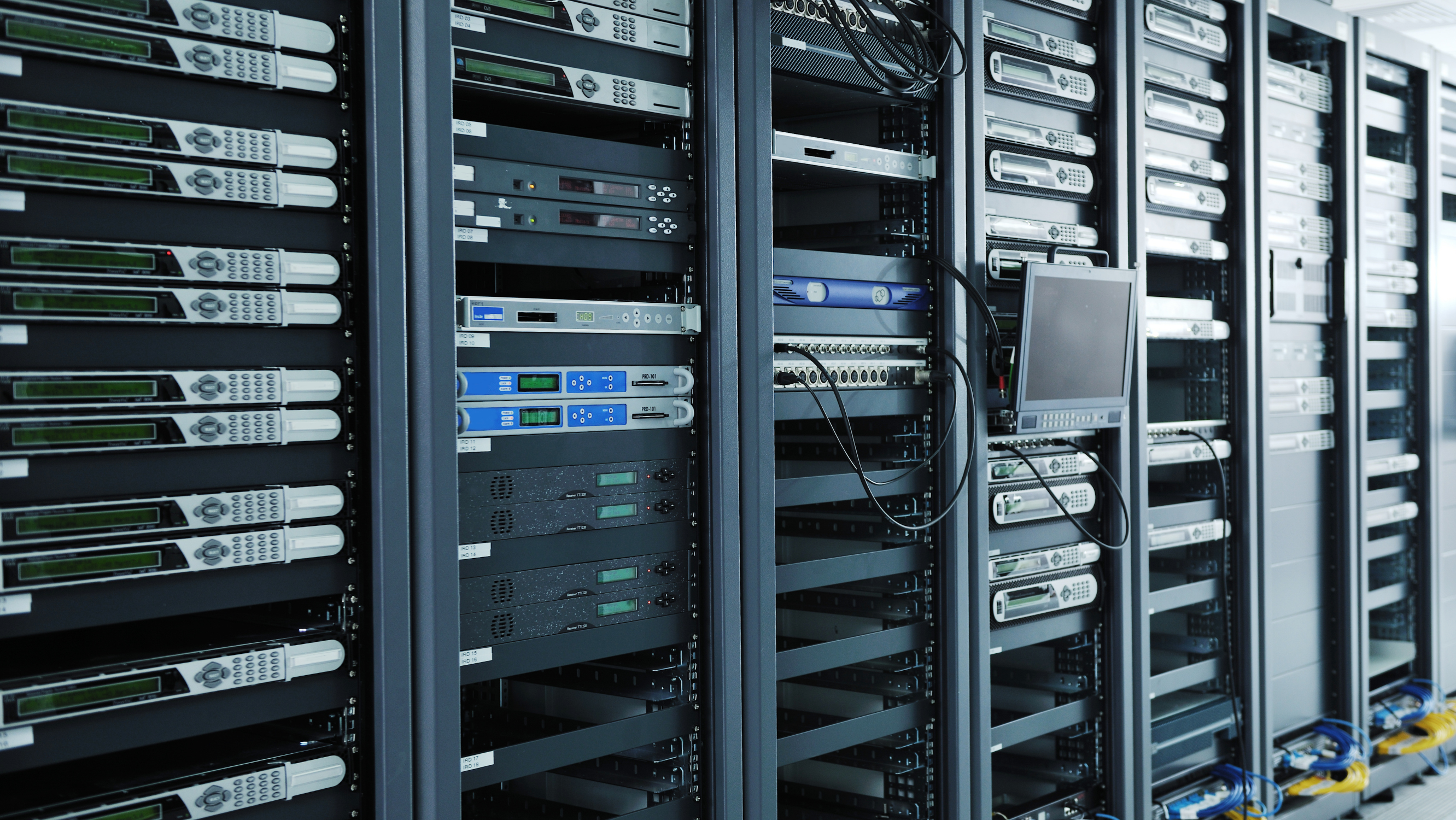 A row of computer servers slightly receding into the distance