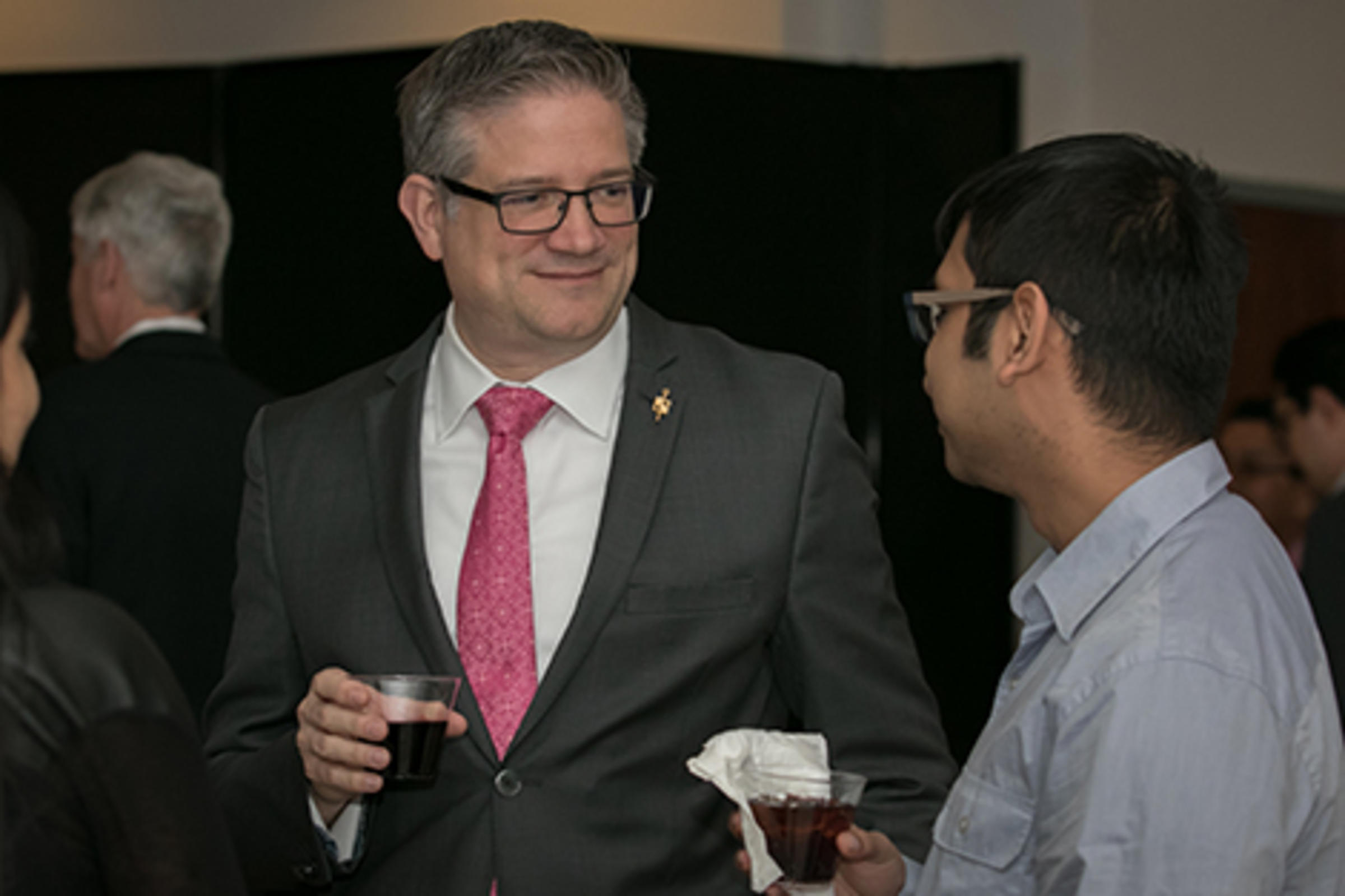 Students and faculty at the Beta Gamma Sigma event.