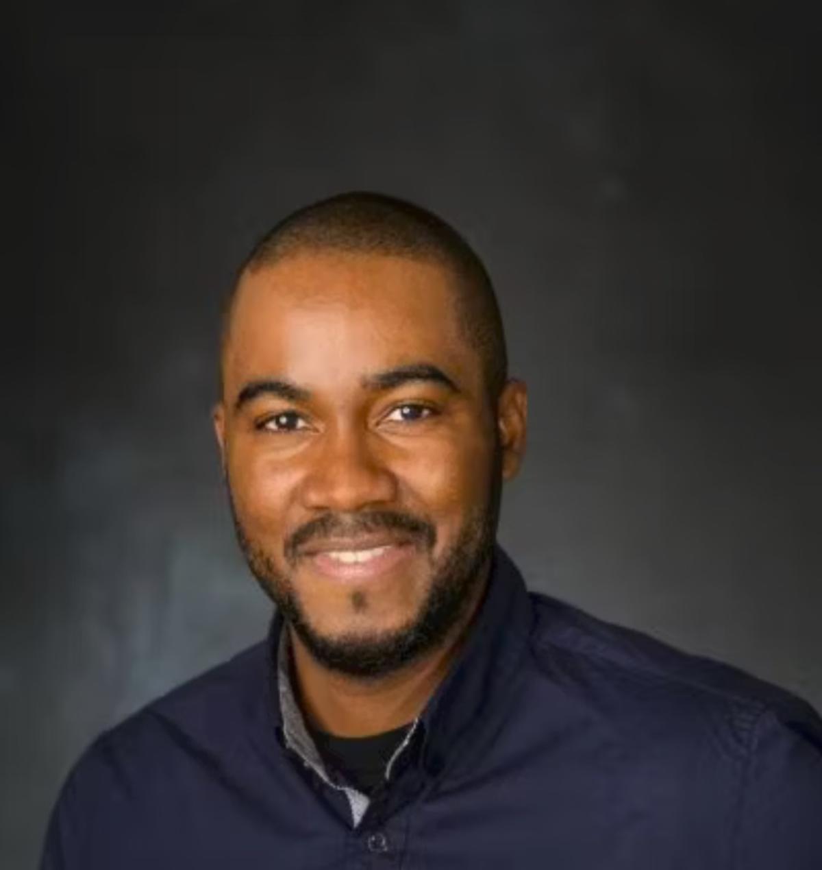 Professional headshot of Denver Baptiste
