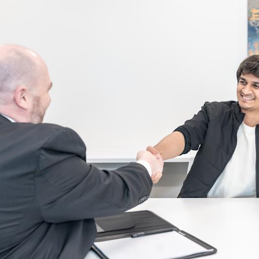 2 people shaking hands