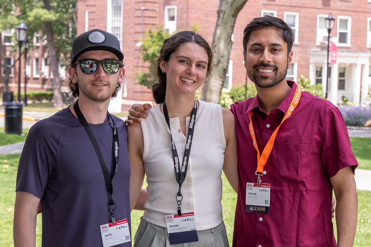 Three young alumni outside on Stevens campus at Alumni Weekend 2026