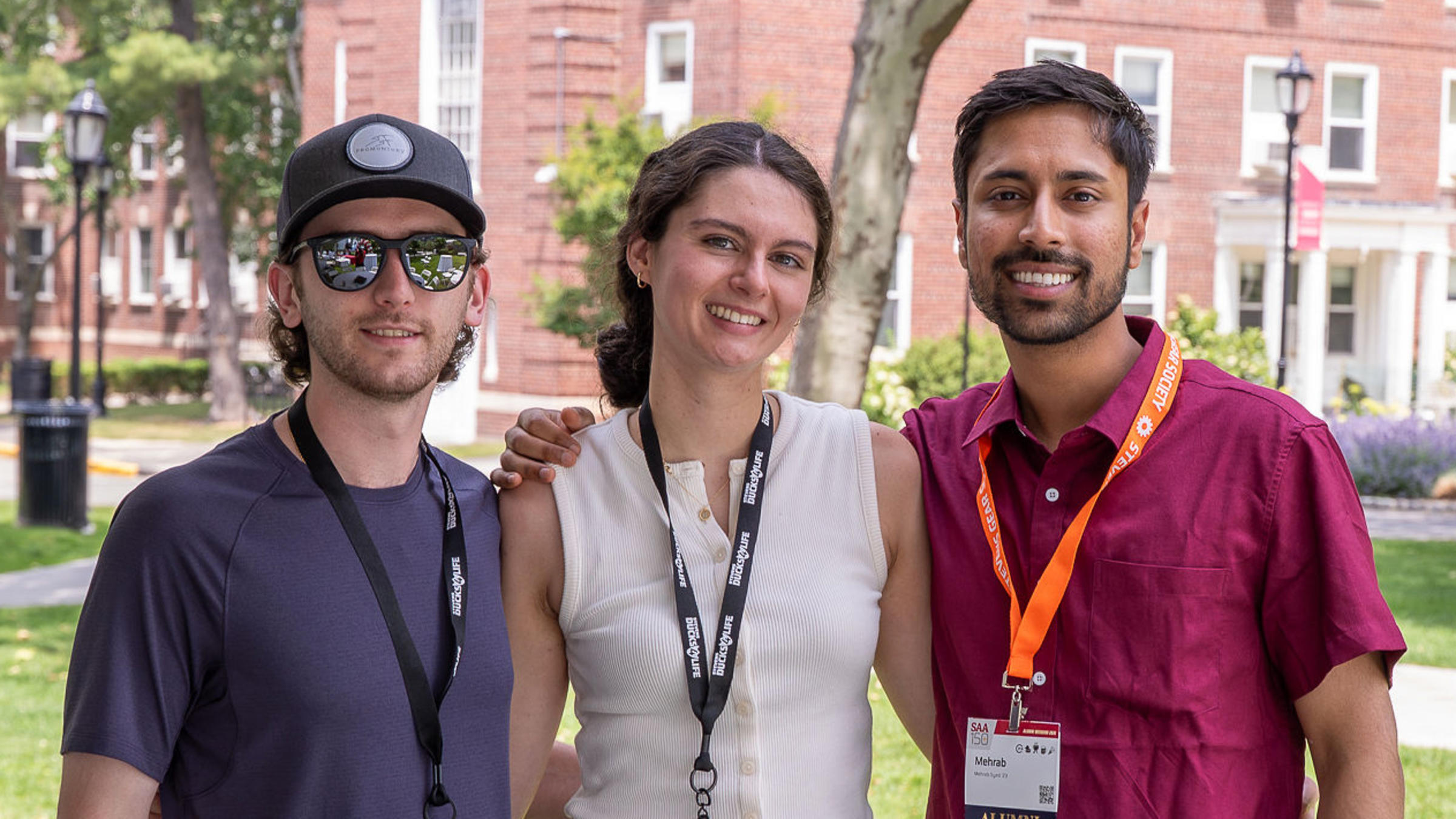 Three young alumni outside on Stevens campus at Alumni Weekend 2026