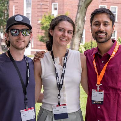 Three young alumni outside on Stevens campus at Alumni Weekend 2026