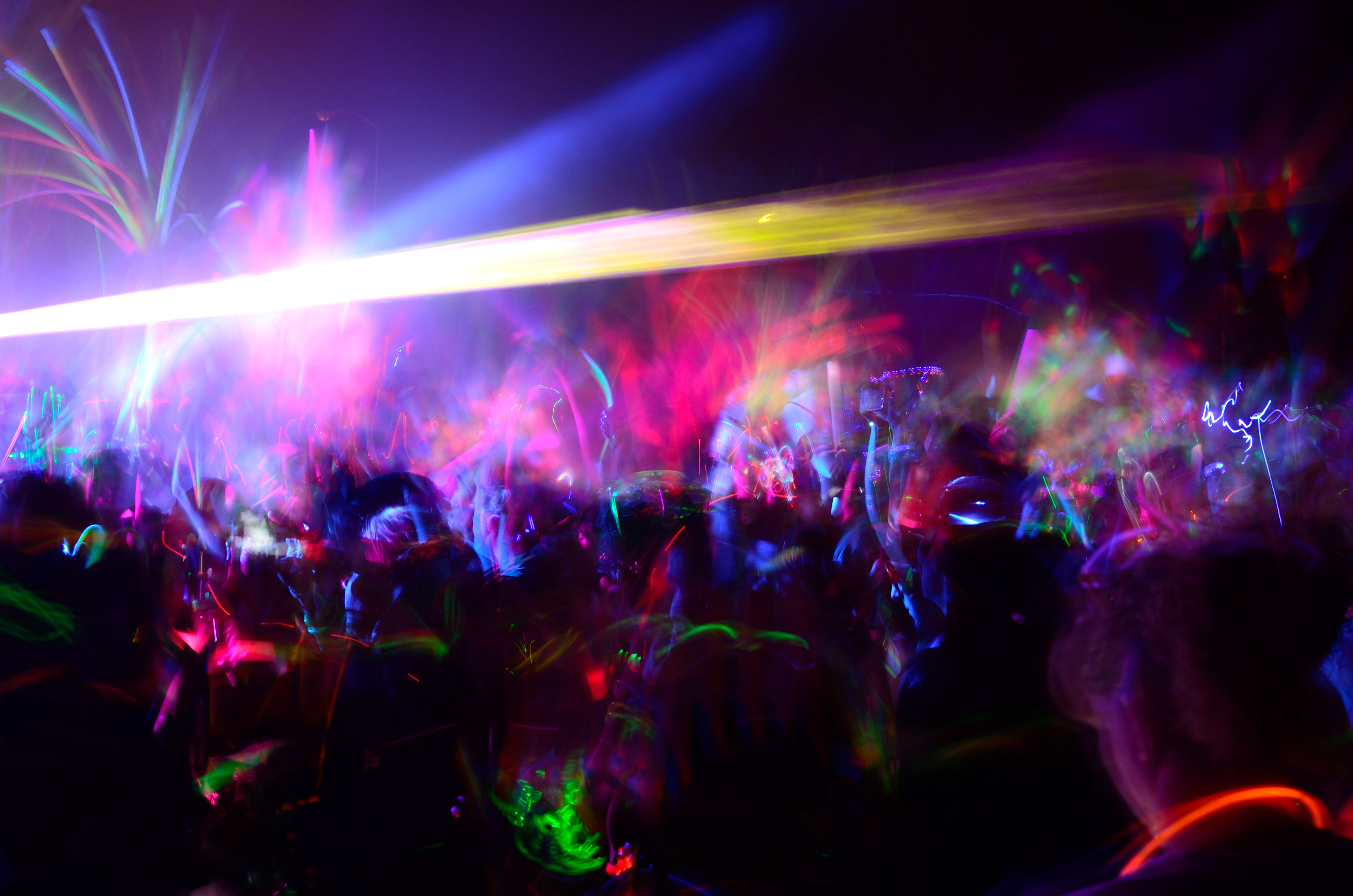 A stock visual of a dance party with glow sticks