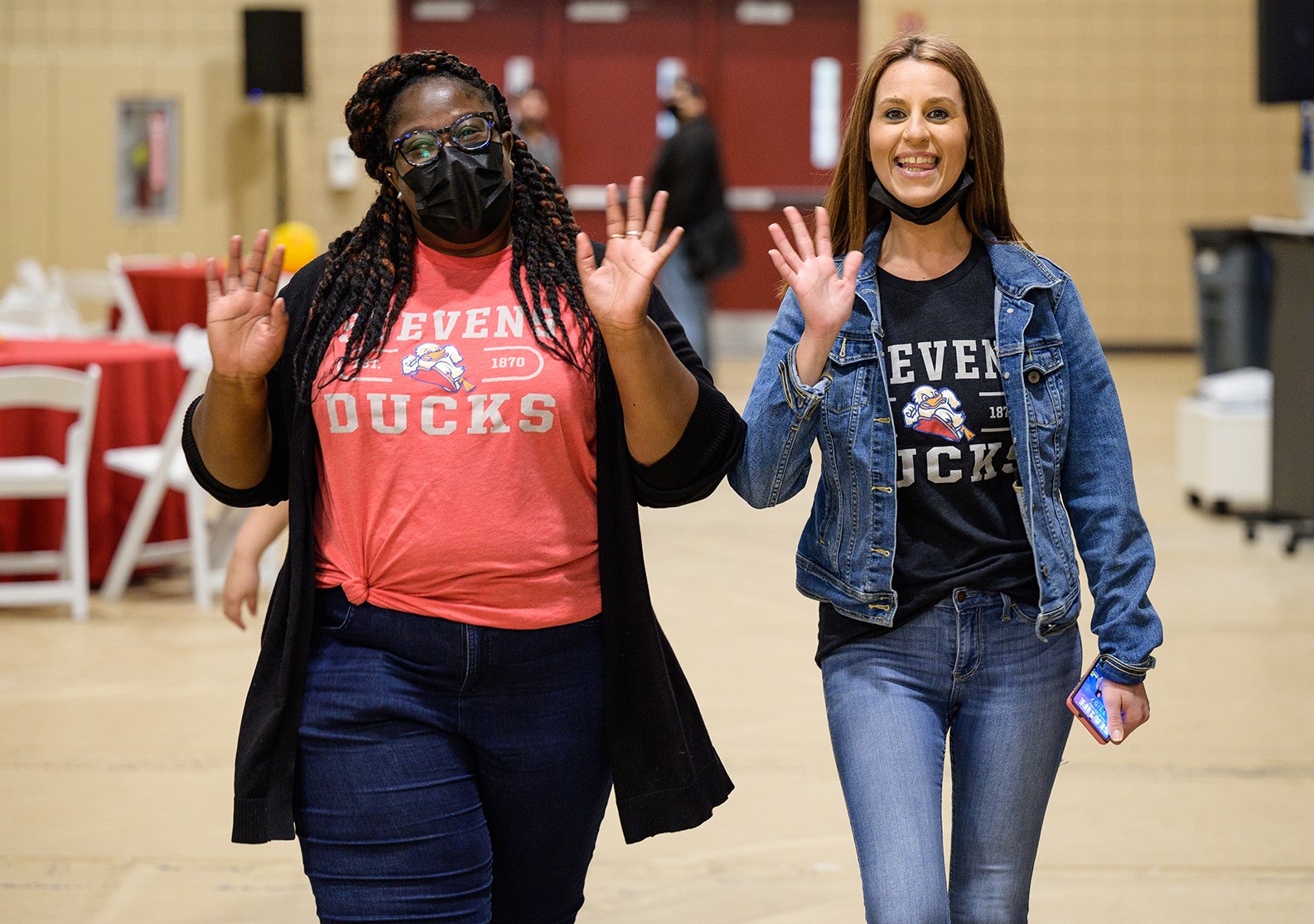 Two women employees in Stevens' T-shirts.