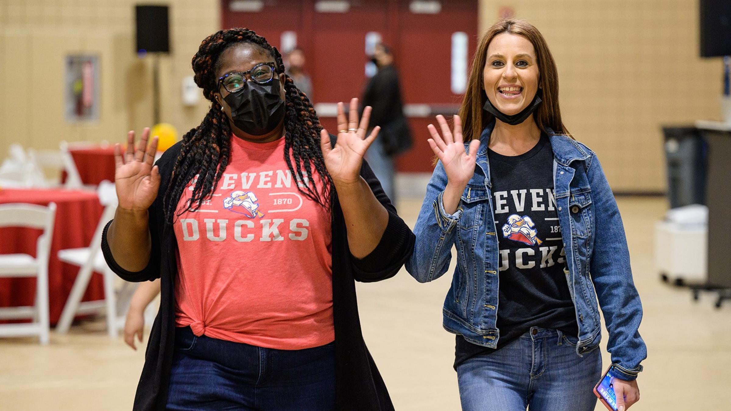 Two women employees in Stevens' T-shirts.
