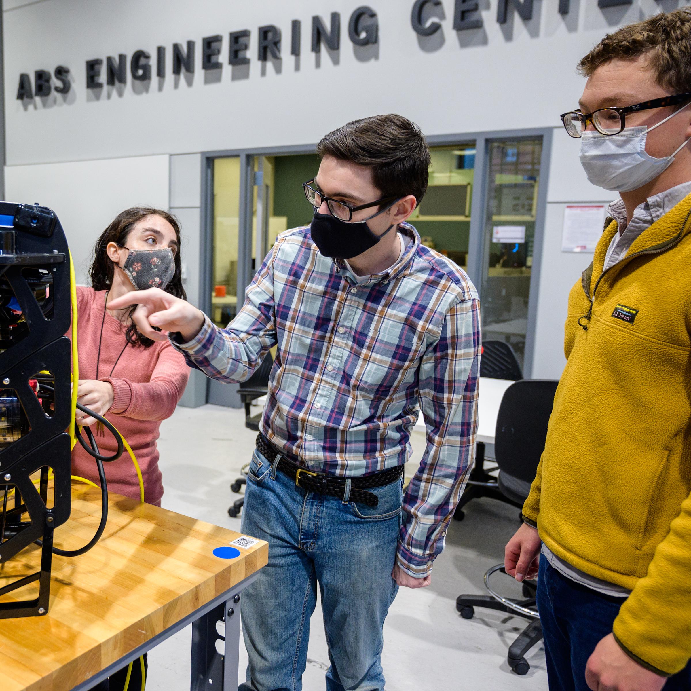 students evaluating robotics project