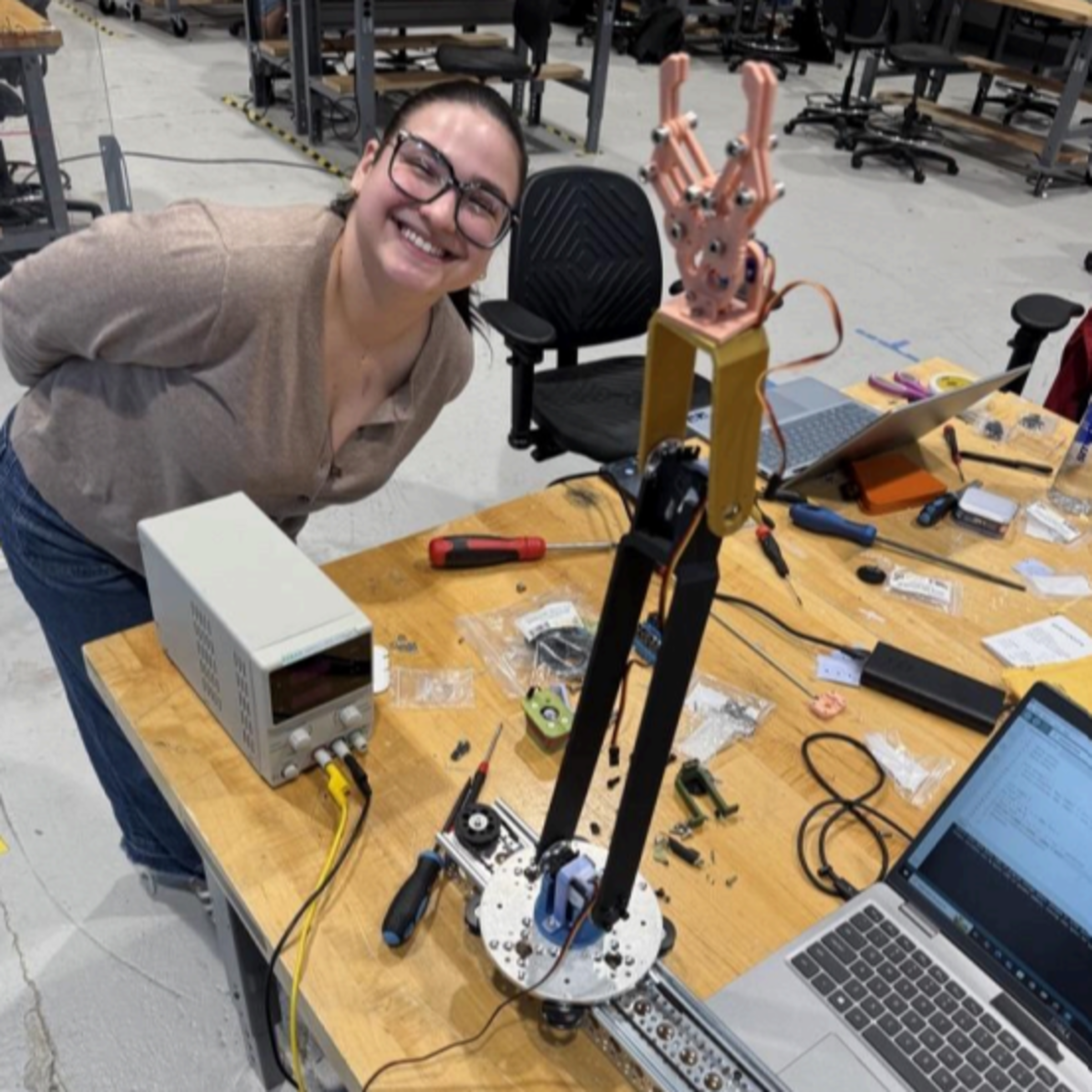 Ekaterini Koukoulis proudly poses with an early testing prototype of the team’s Autonomous IV System.