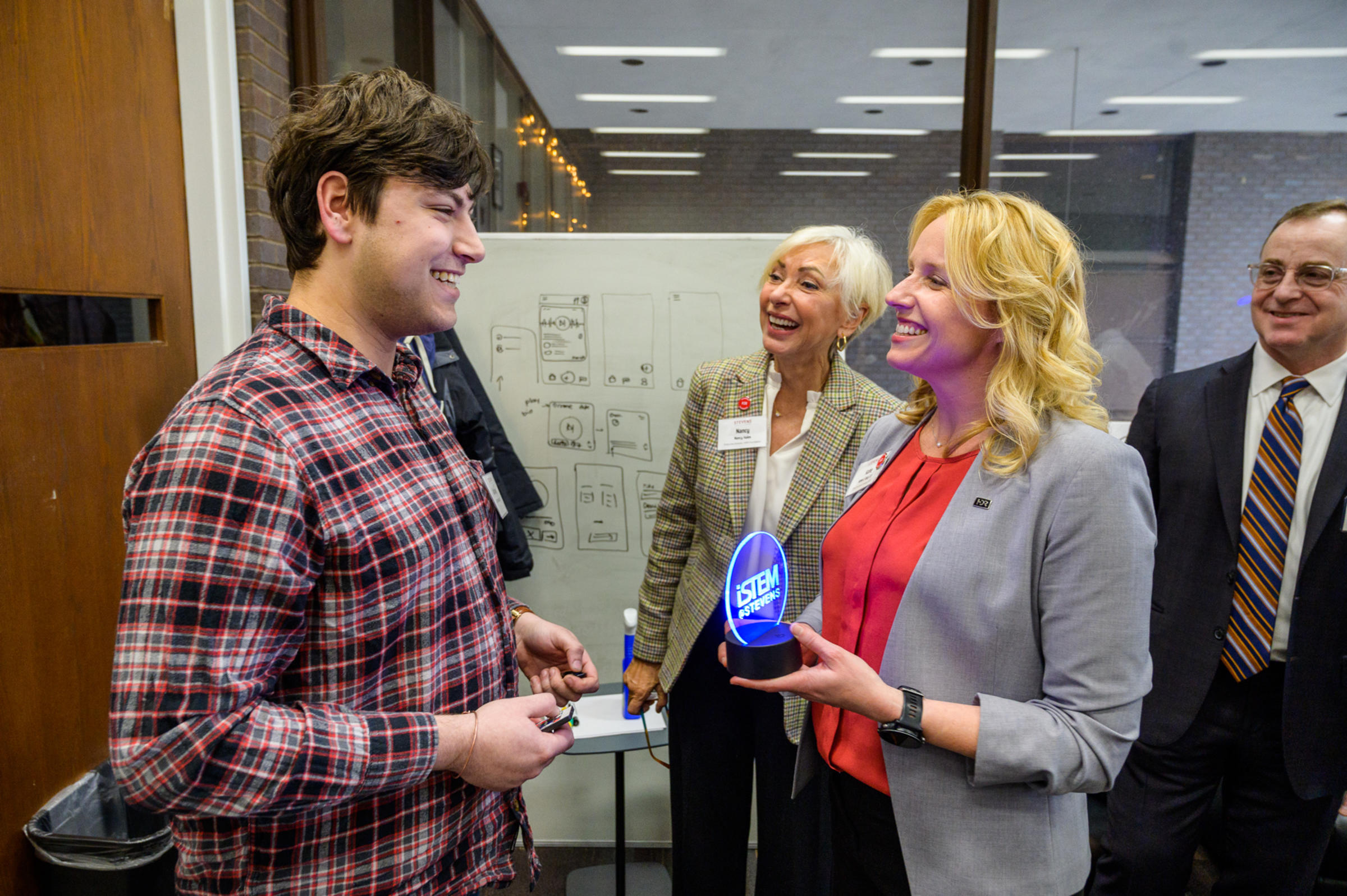 Student receives iStem @ Stevens recognition from three professionals