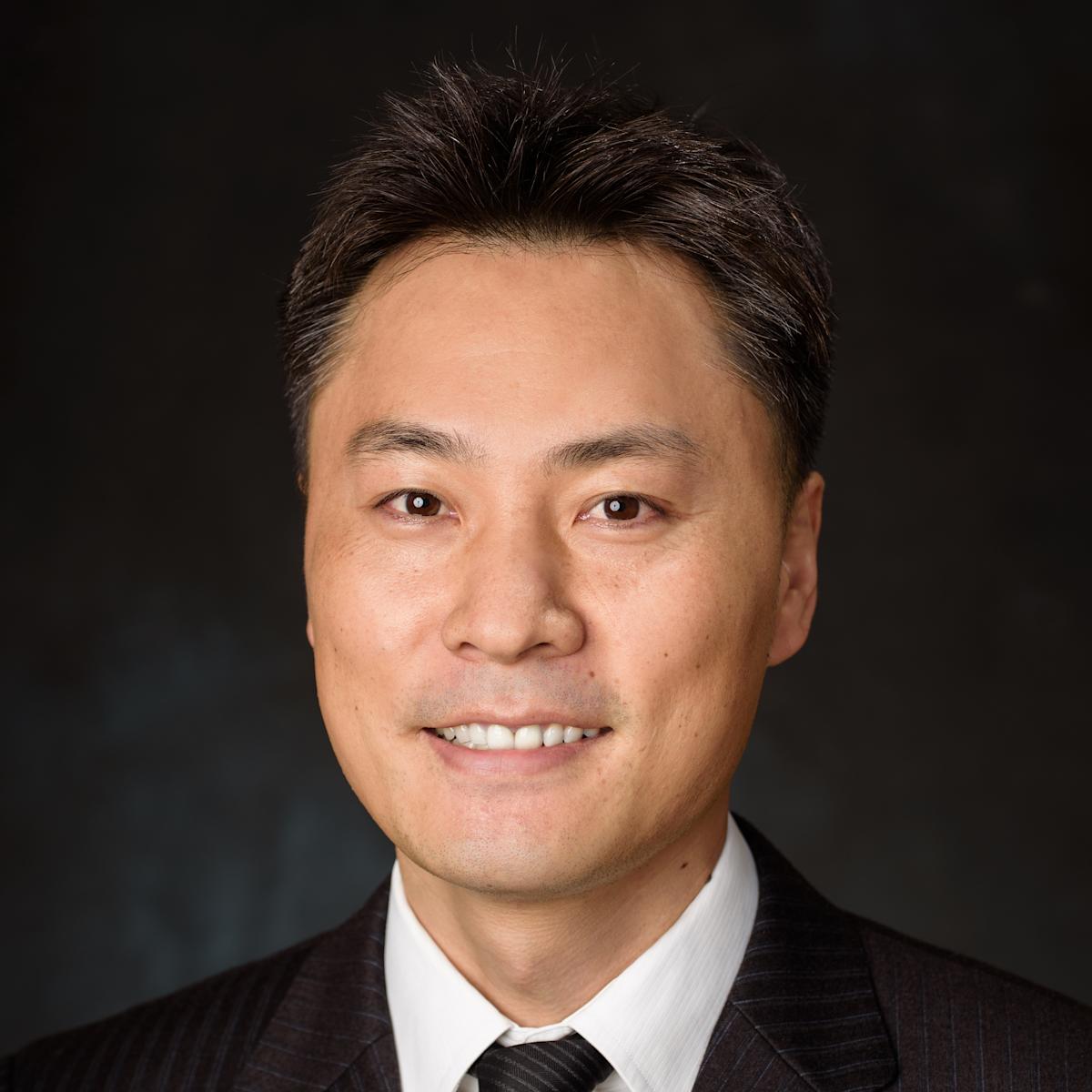 A formal, professional headshot of Jinho Kim