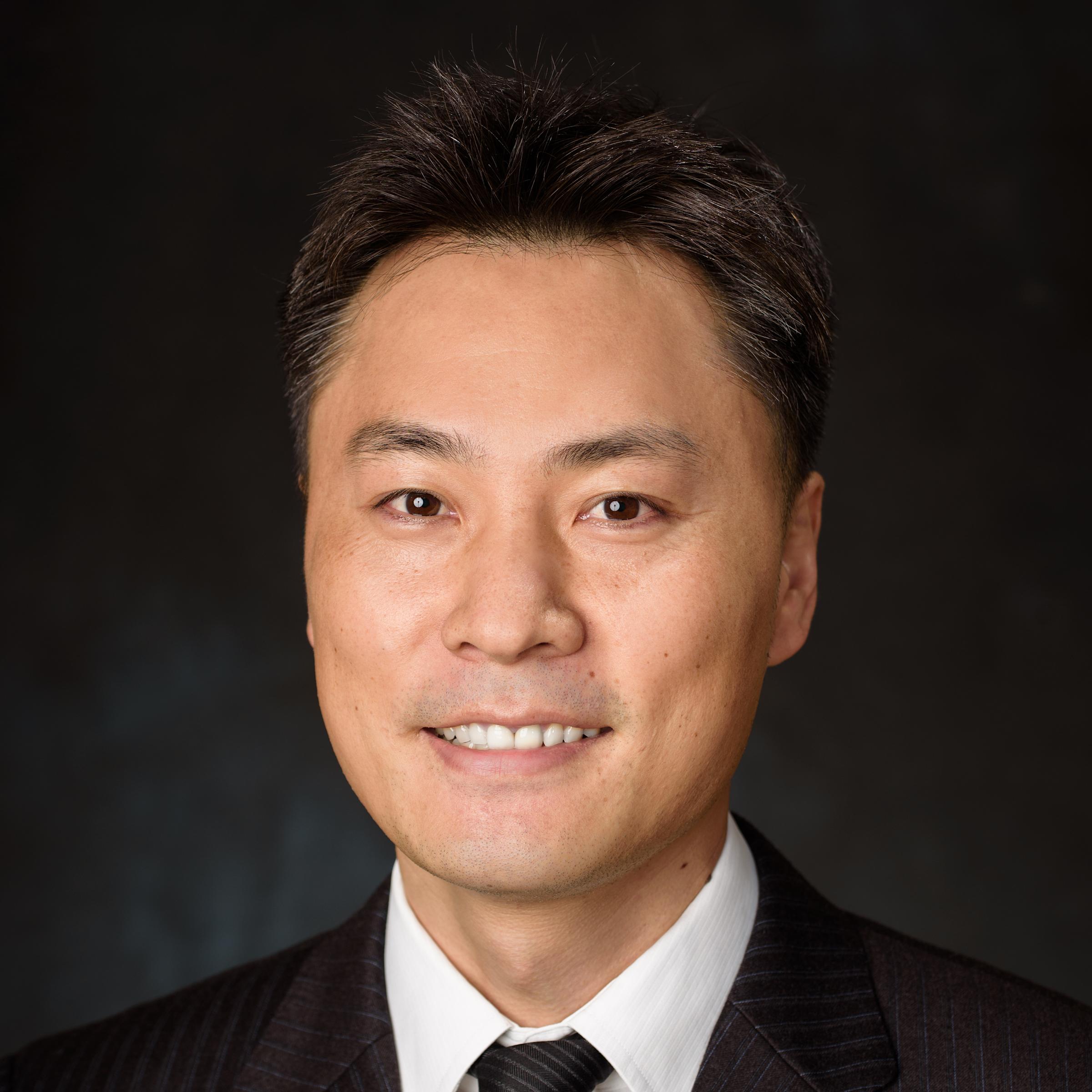 A formal, professional headshot of Jinho Kim